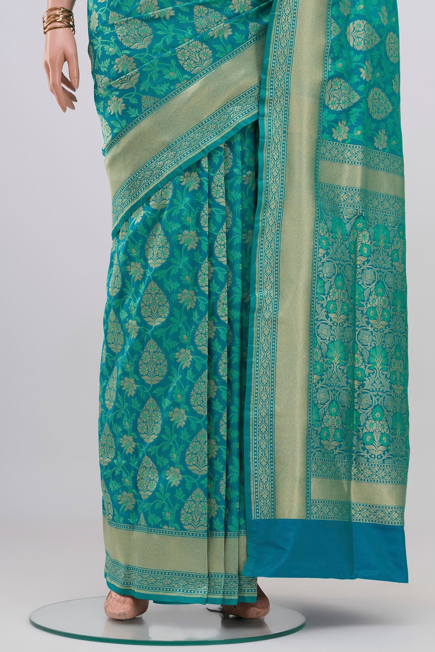 Pleats and pallu of Blue Banarasi Silk Saree with Zari And Thread Butta on the body and Zari Border. 