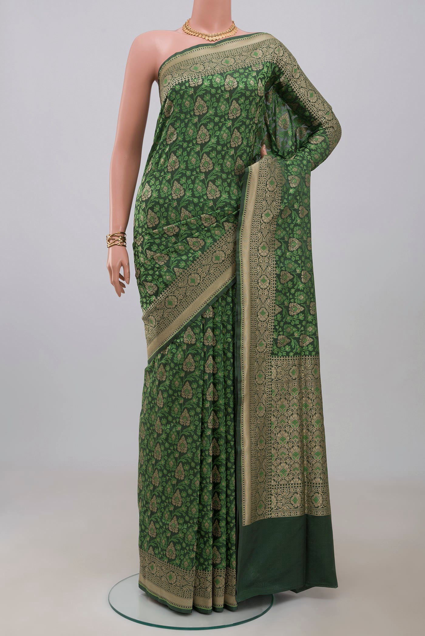Green Banarasi Saree with Fancy on the body and Fancy Border.  displayed on a mannequin