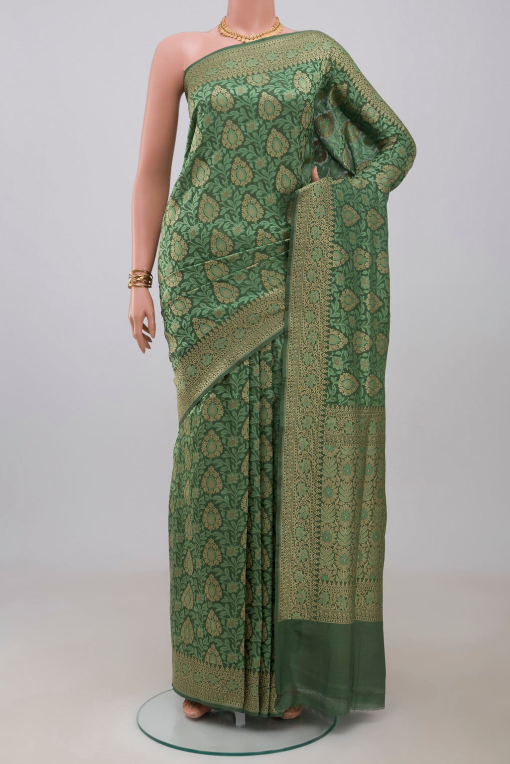 Green Banarasi Silk Saree with Jacquard With Zari Butta on the body and Fancy Border.  displayed on a mannequin