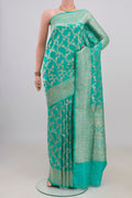 Pure Silk Turquoise Banarasi Saree with Zari Brocade on the body and Zari Border.  displayed on a mannequin