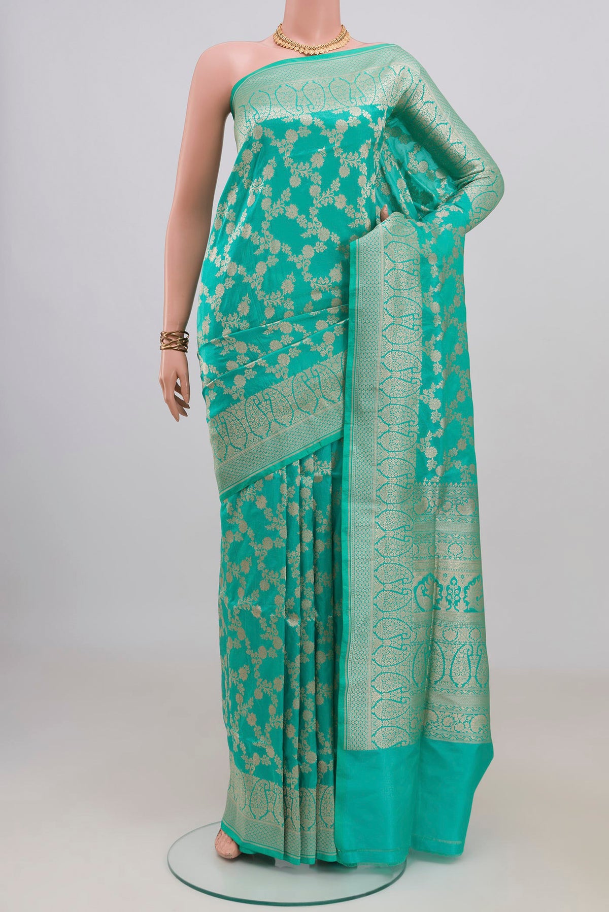 Pure Silk Turquoise Banarasi Saree with Zari Brocade on the body and Zari Border.  displayed on a mannequin