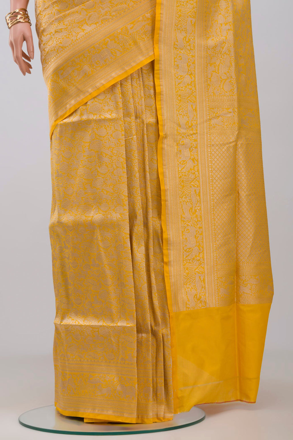 Pleats and pallu of Yellow Banarasi Saree with Zari Brocade on the body and Fancy Border. 
