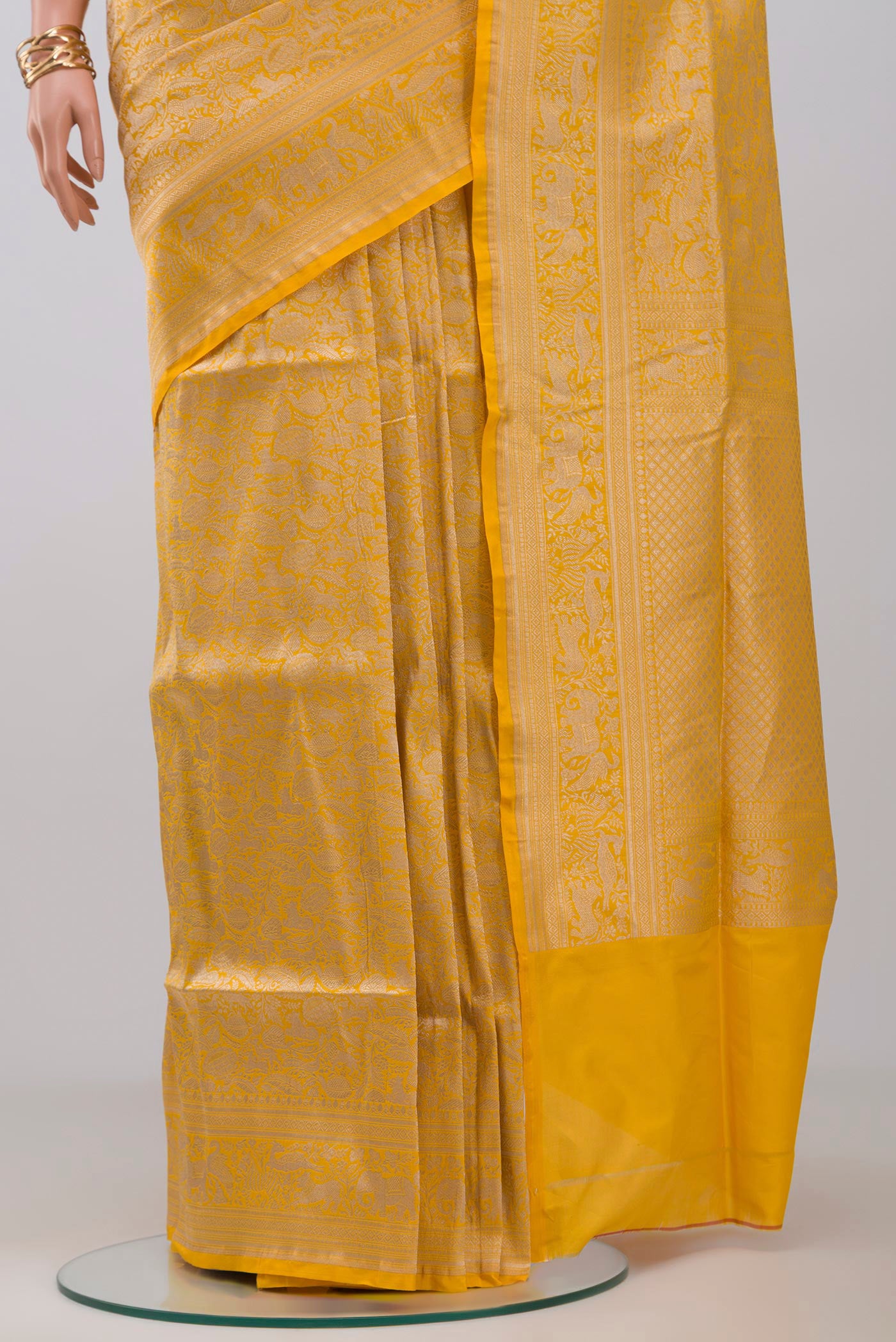 Pleats and pallu of Yellow Banarasi Saree with Zari Brocade on the body and Fancy Border. 