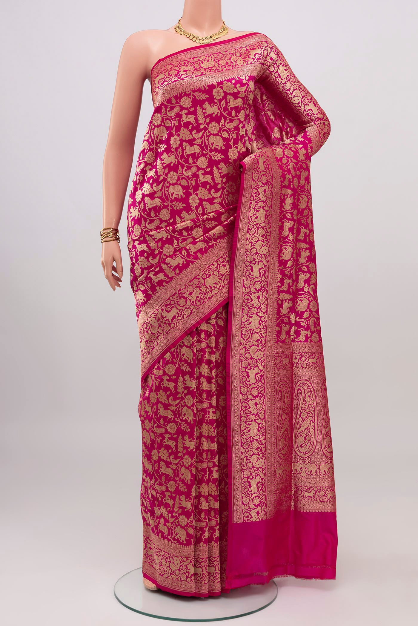 Rani Pink Banarasi Silk Saree with Zari Brocade on the body and Zari Border.  displayed on a mannequin