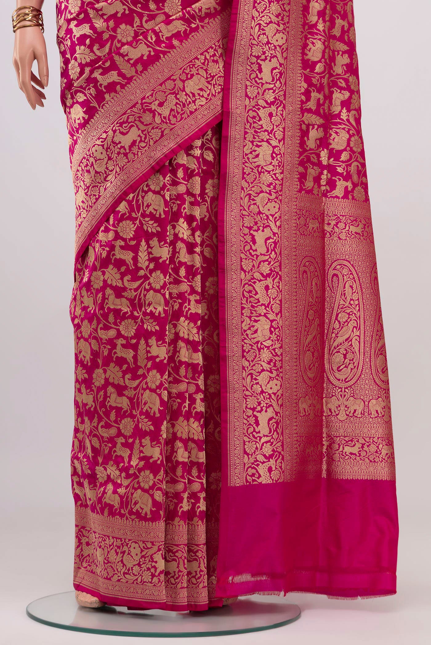 Pleats and pallu of Rani Pink Banarasi Silk Saree with Zari Brocade on the body and Zari Border. 