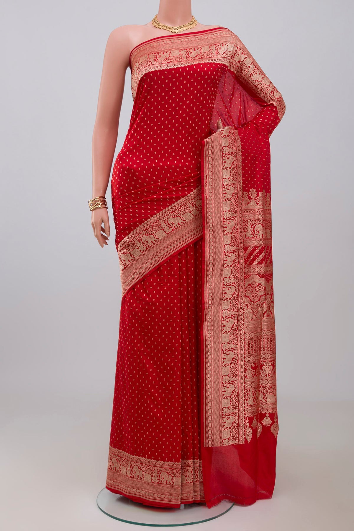 Red Banarasi Saree with Zari Butta on the body and Fancy Border.  displayed on a mannequin