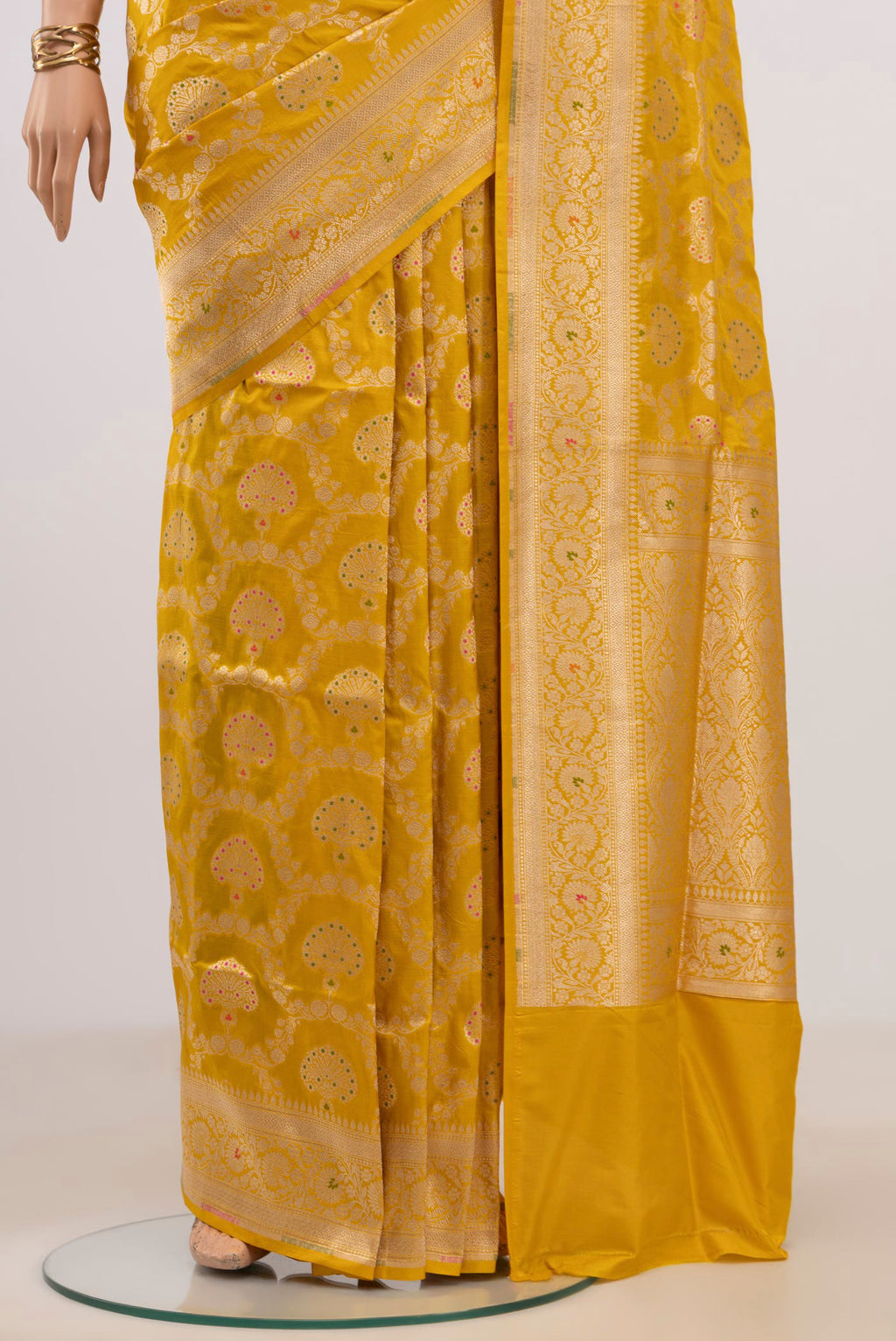Pleats and pallu of Yellow Banarasi Saree with Zari Brocade on the body and Fancy Border. 