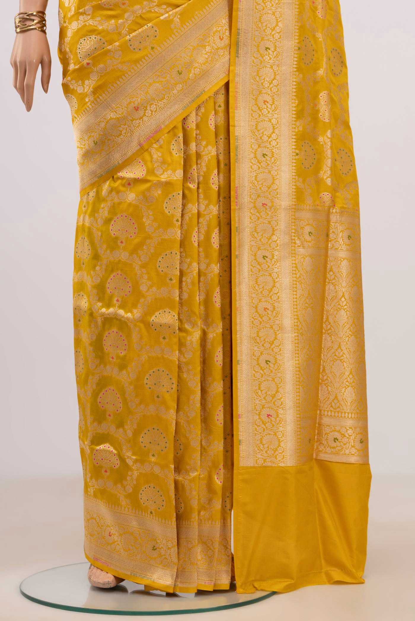 Pleats and pallu of Yellow Banarasi Saree with Zari Brocade on the body and Fancy Border. 