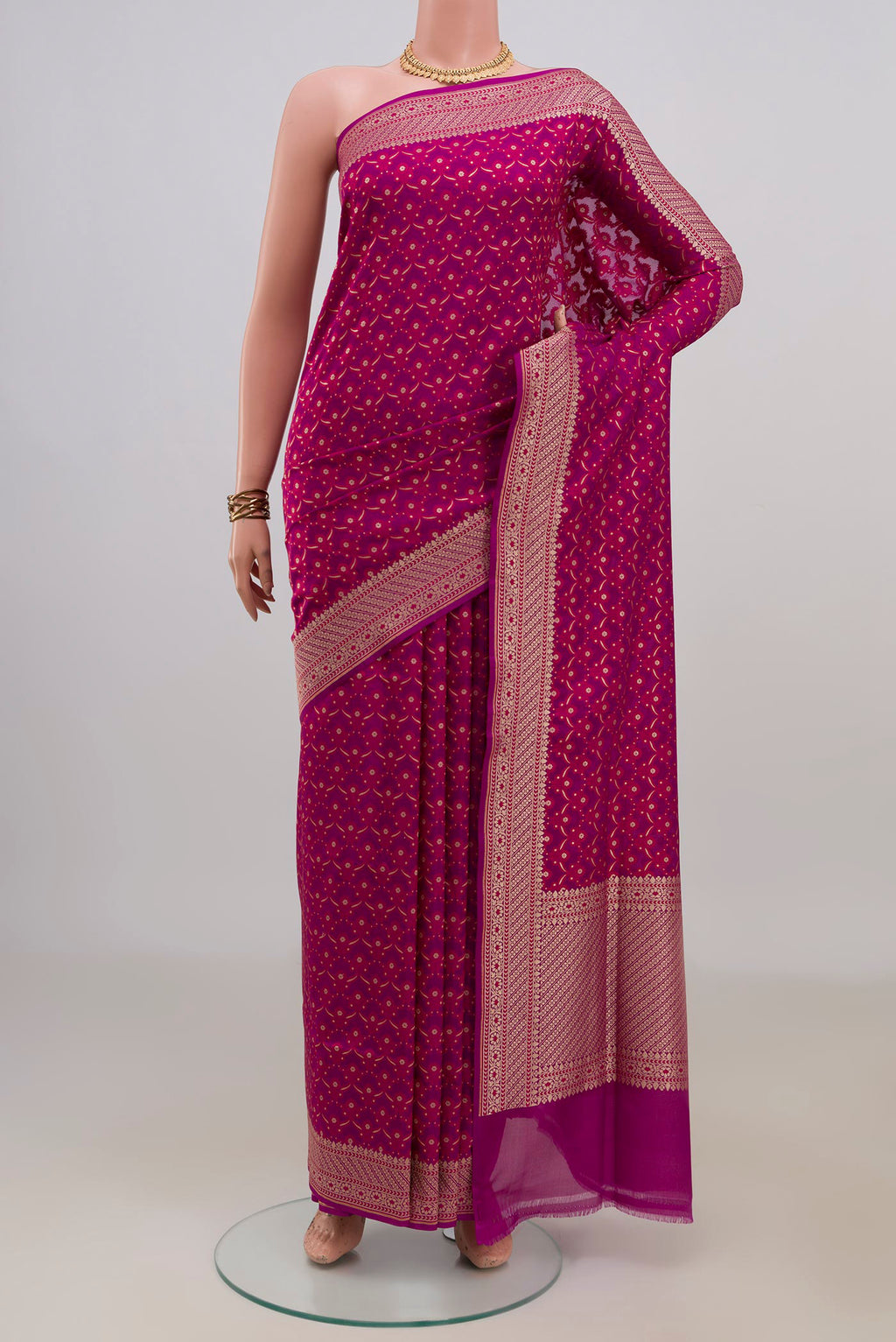 Pure Silk Magenta Banarasi Saree with Zari And Thread Butta on the body and Zari Border.  displayed on a mannequin