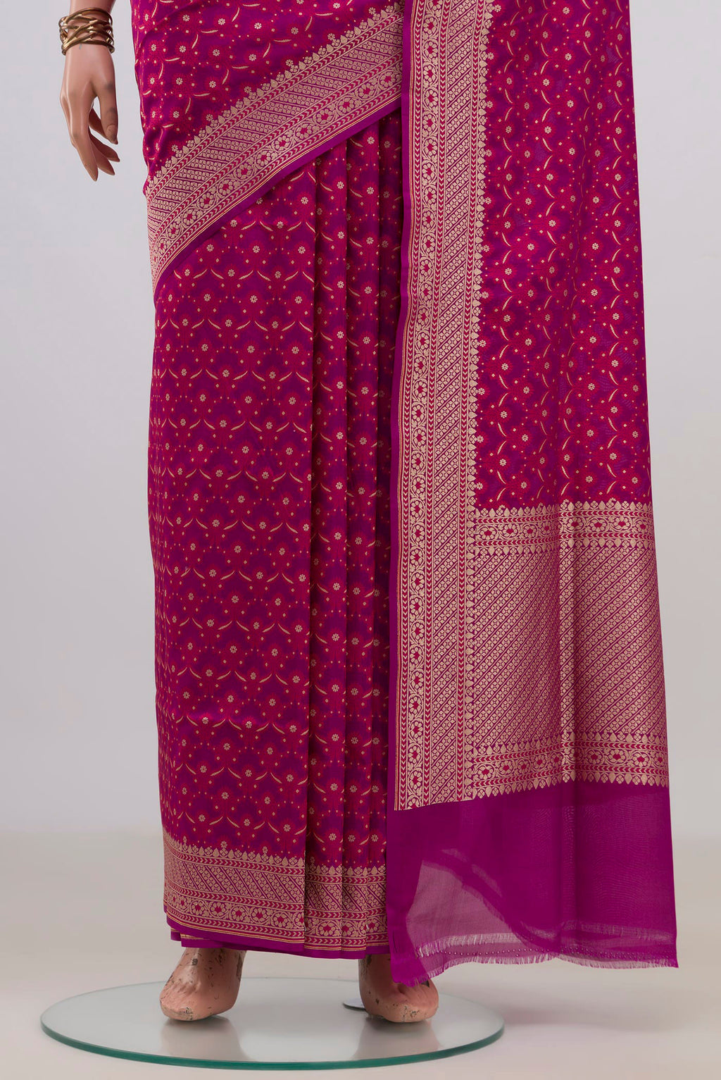 Pleats and pallu of Pure Silk Magenta Banarasi Saree with Zari And Thread Butta on the body and Zari Border. 