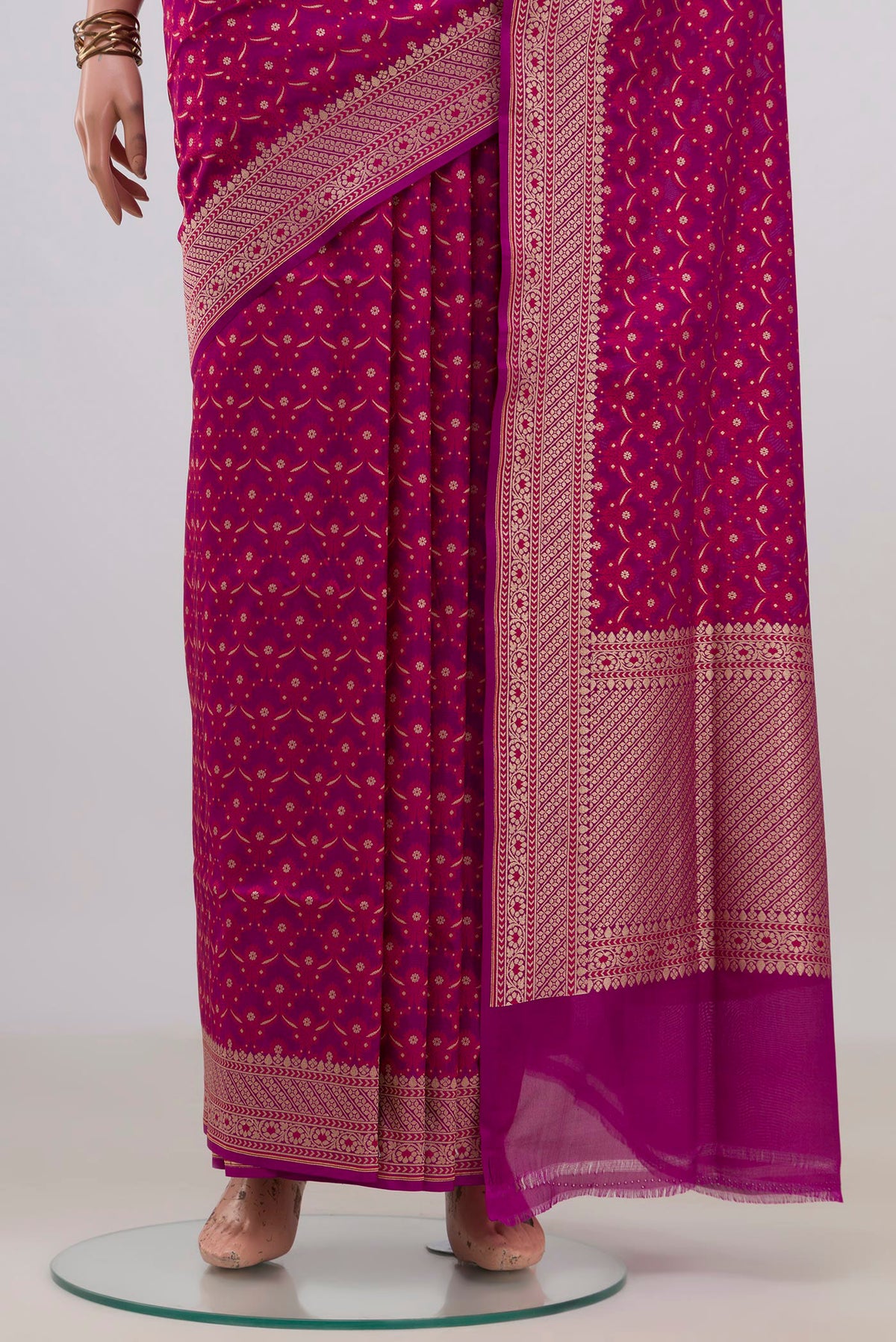 Pleats and pallu of Pure Silk Magenta Banarasi Saree with Zari And Thread Butta on the body and Zari Border. 