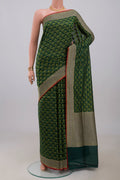 Green Banarasi Saree with Fancy on the body and Fancy Border.  displayed on a mannequin