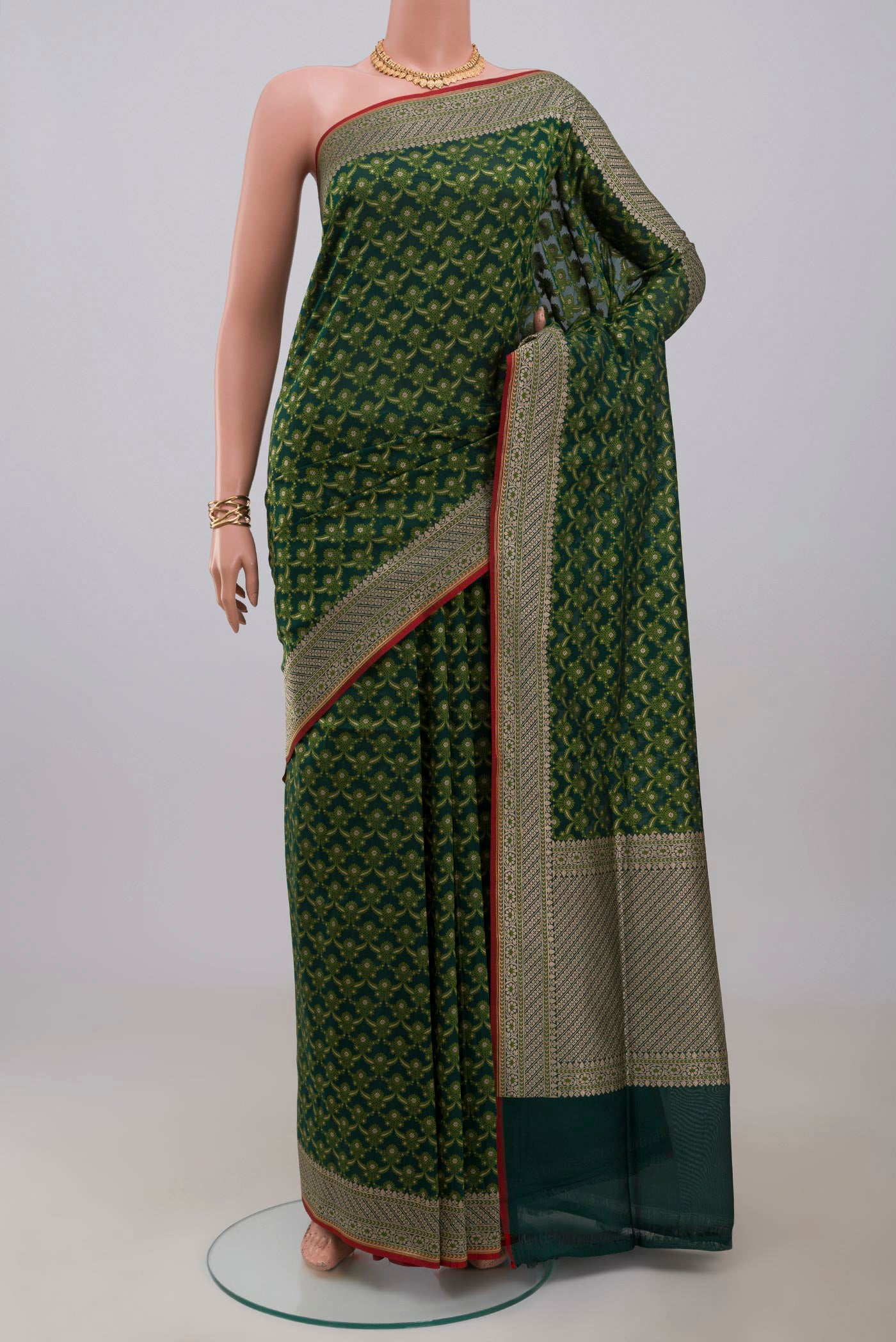 Green Banarasi Saree with Fancy on the body and Fancy Border.  displayed on a mannequin