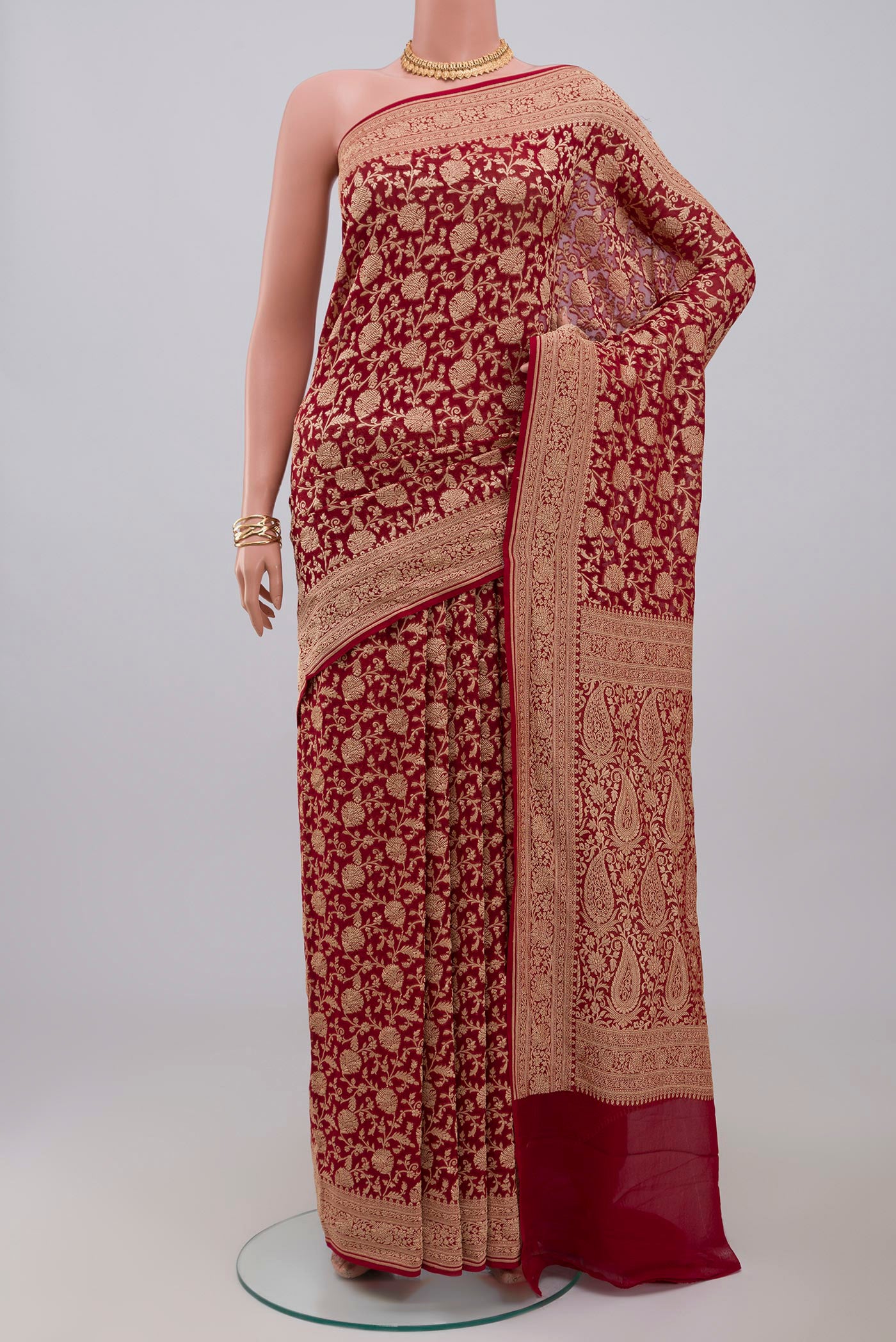Red Georgette Saree with Fancy on the body and Zari Border.  displayed on a mannequin