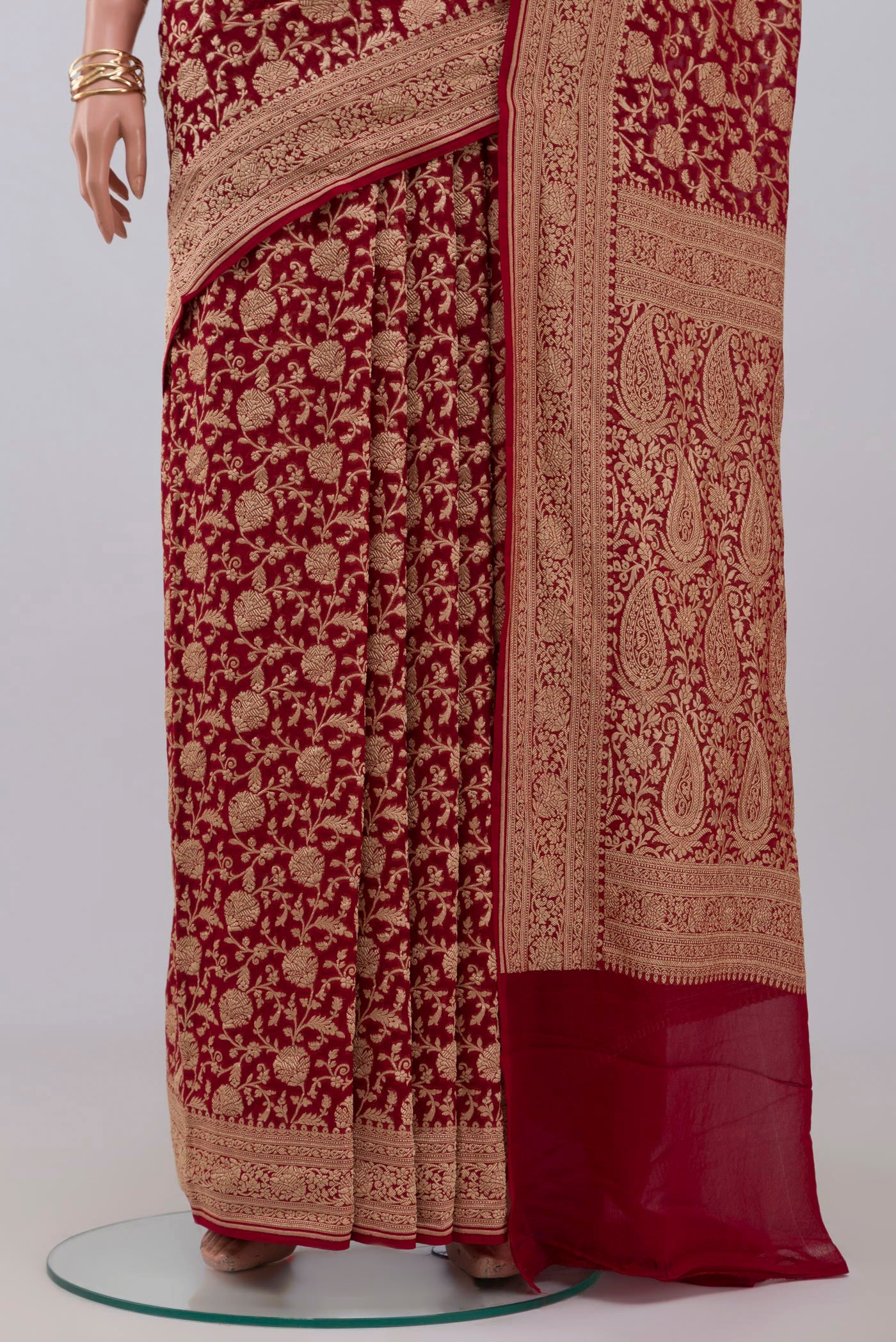 Pleats and pallu of Red Georgette Saree with Fancy on the body and Zari Border. 