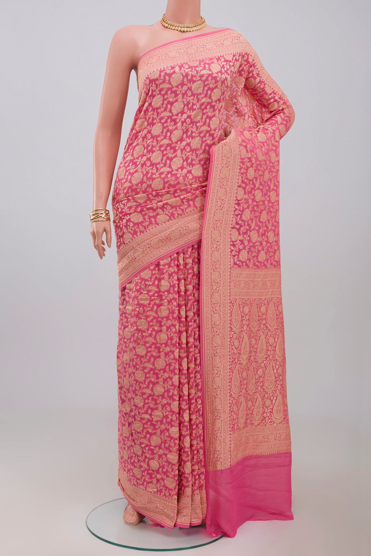 Pink Georgette Saree with Fancy on the body and Zari Border.  displayed on a mannequin