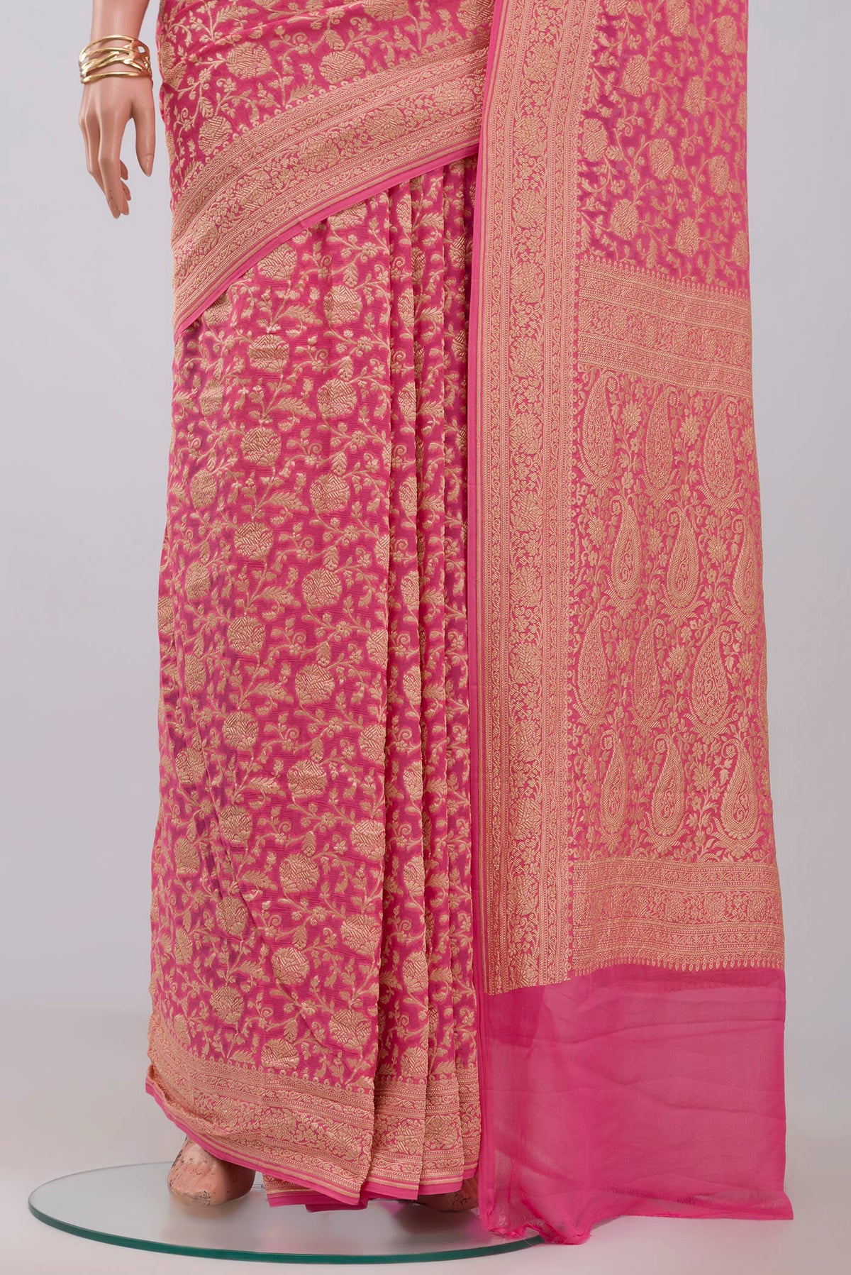 Pleats and pallu of Pink Georgette Saree with Fancy on the body and Zari Border. 