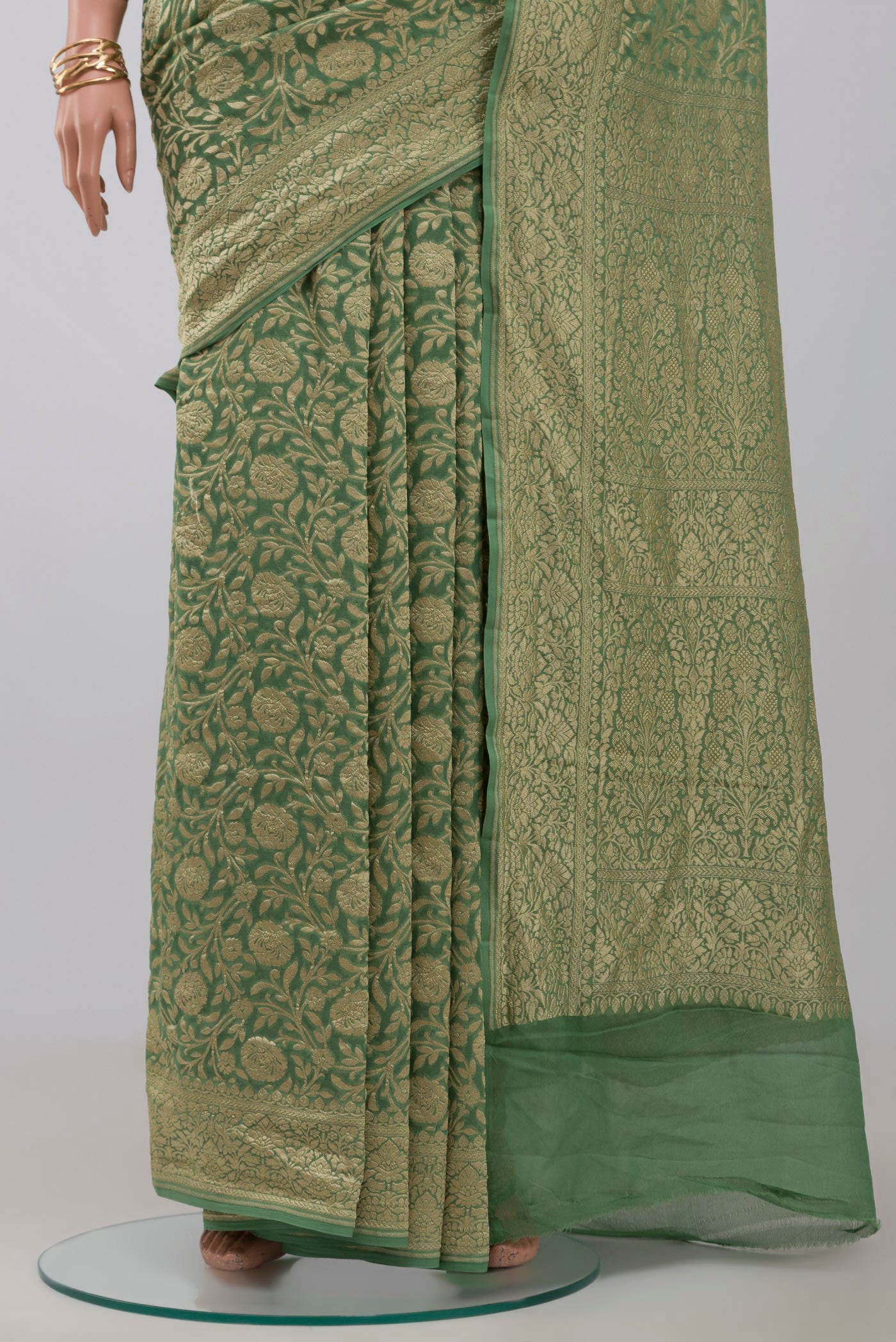 Pleats and pallu of Green Georgette Saree with Fancy on the body and Zari Border. 