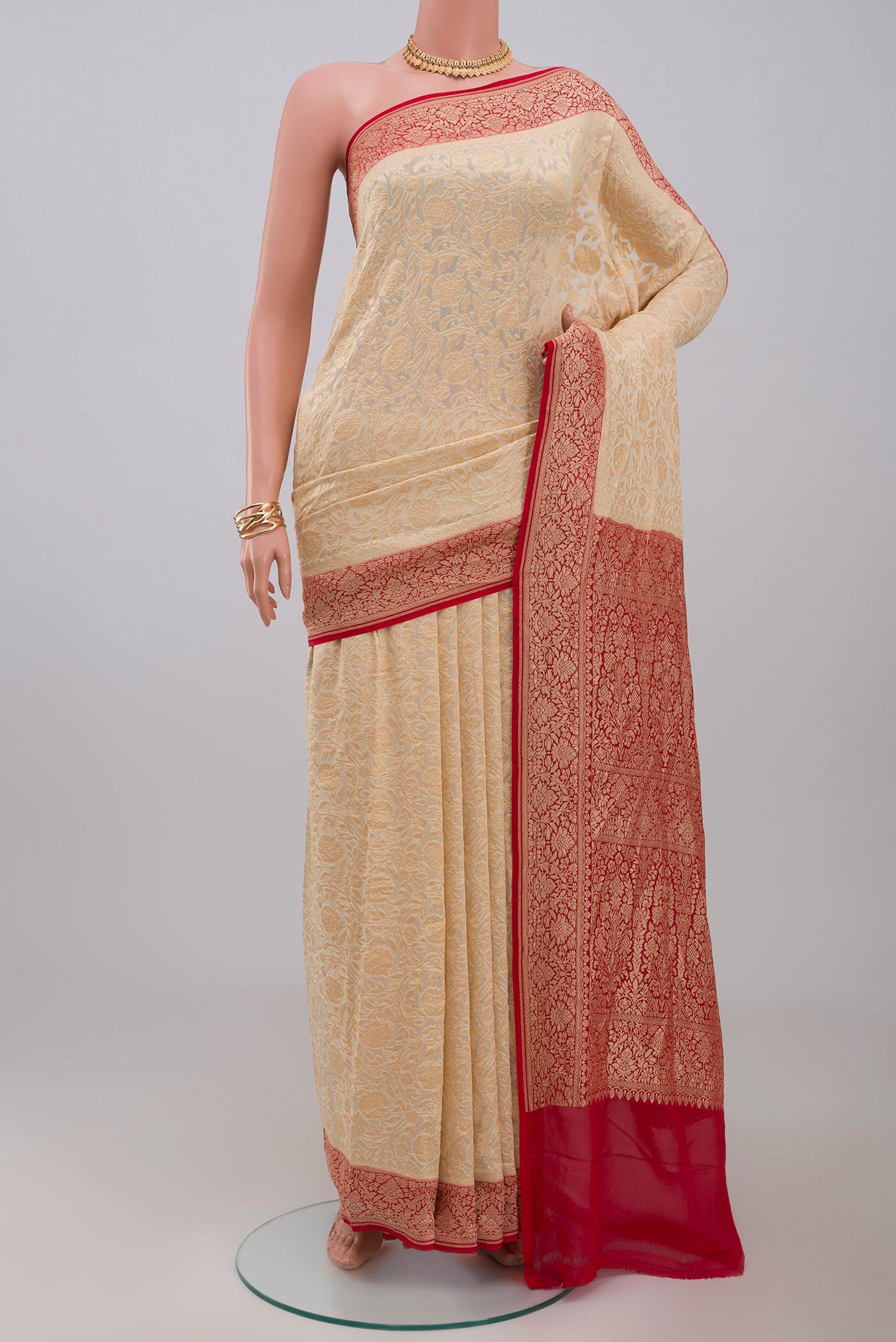 Cream Georgette Saree with Fancy on the body and Zari Border.  displayed on a mannequin