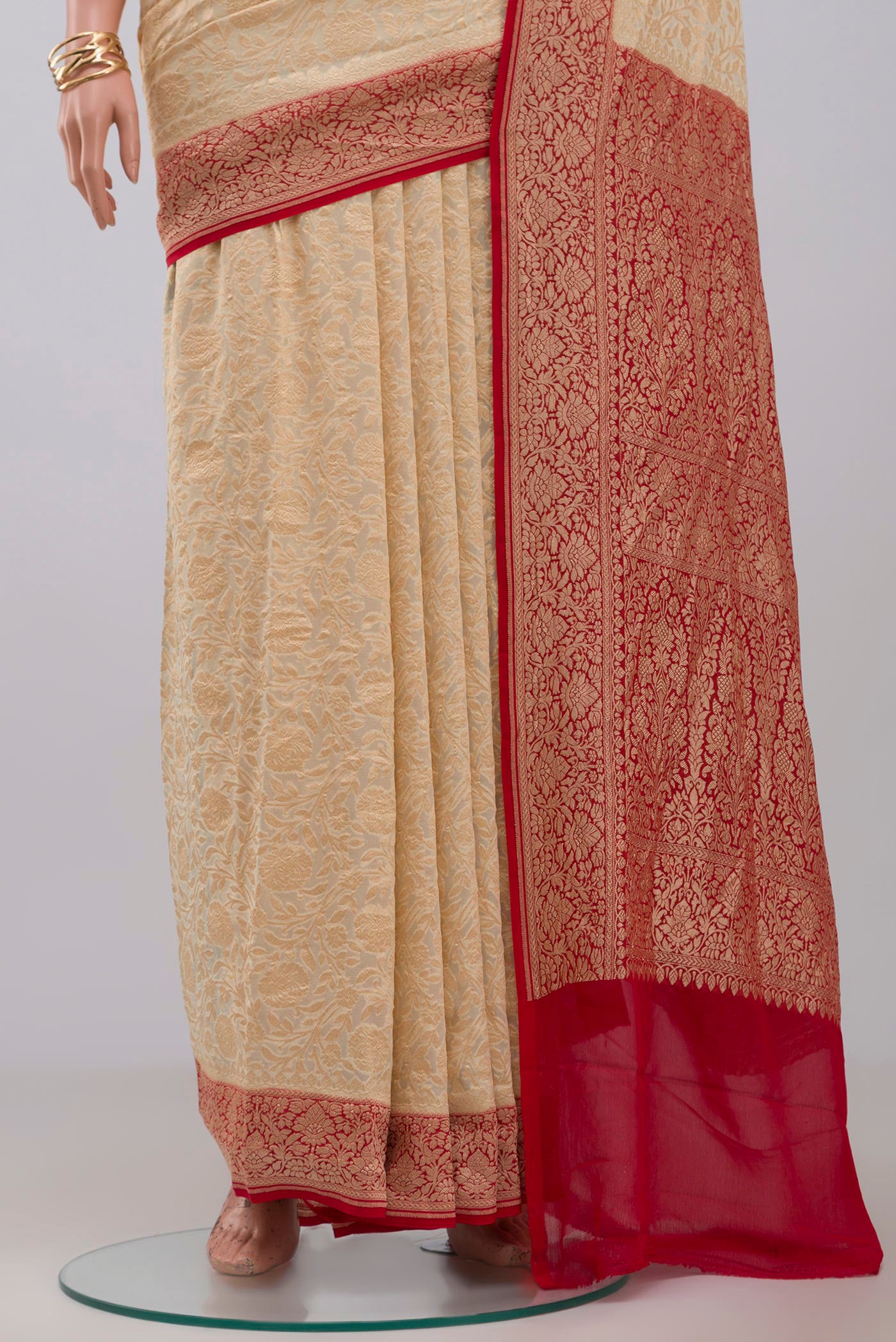 Pleats and pallu of Cream Georgette Saree with Fancy on the body and Zari Border. 