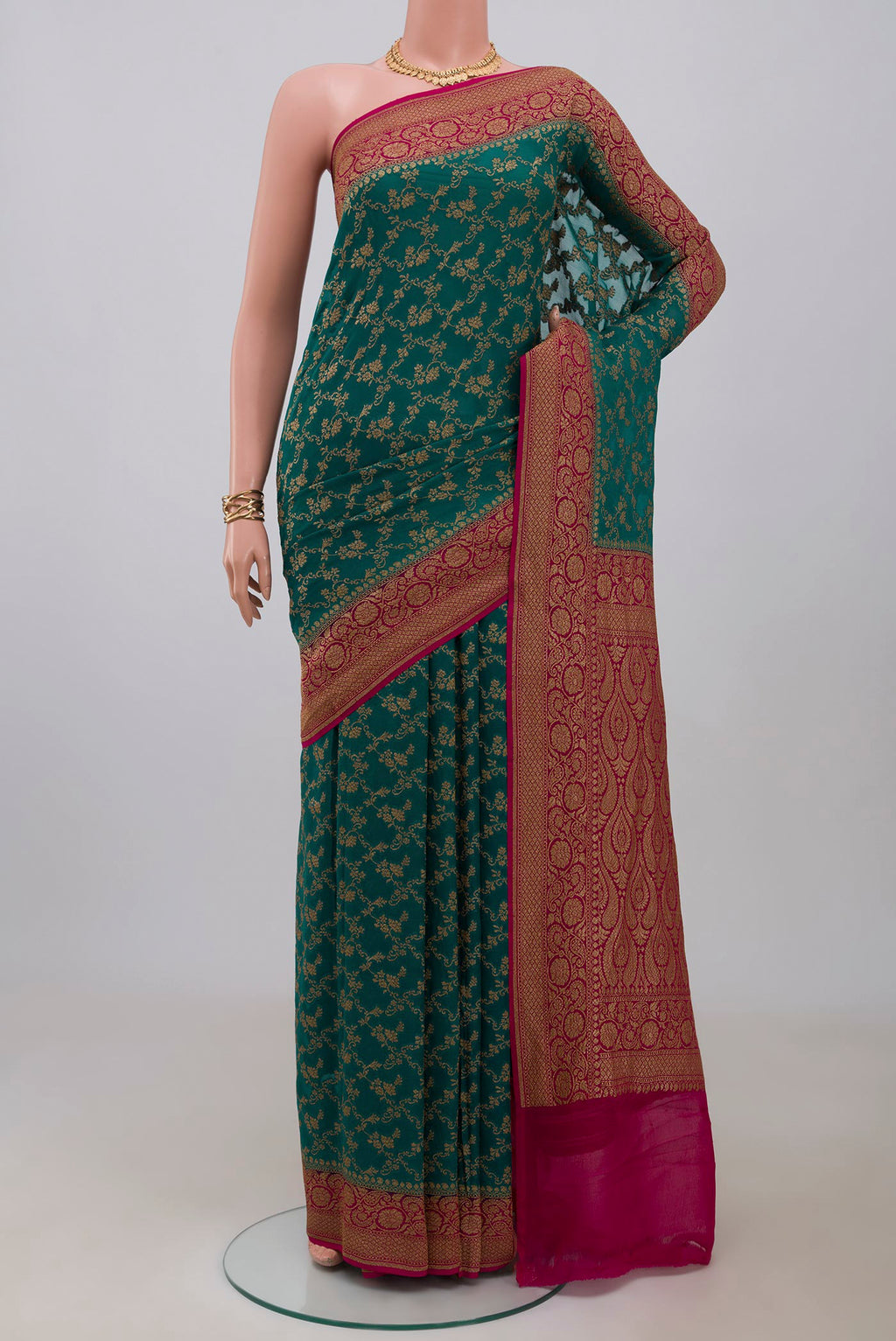 Green Georgette Saree with Fancy on the body and Fancy Border.  displayed on a mannequin