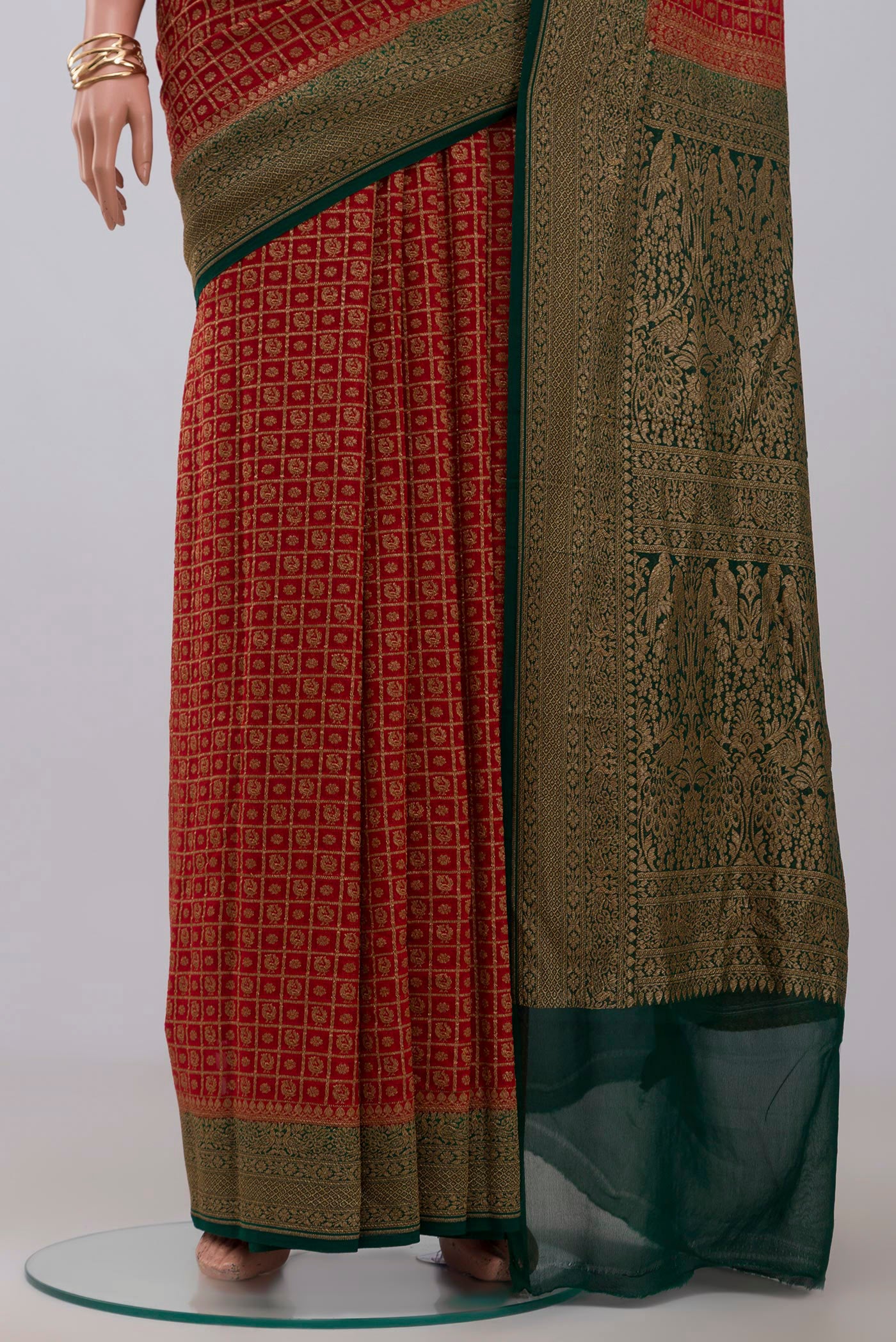 Pleats and pallu of Maroon Georgette Saree with Fancy on the body and Zari Border. 