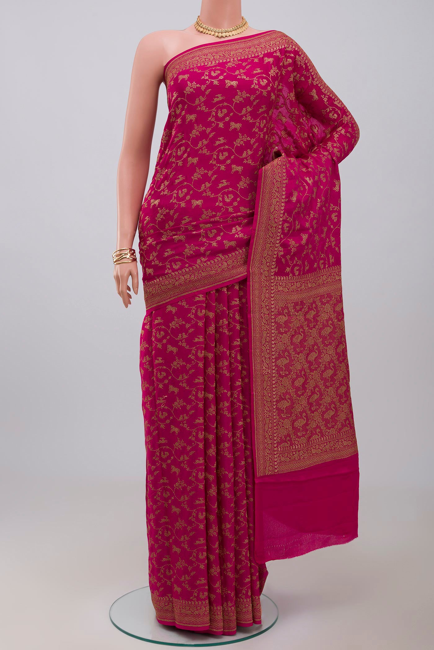 Pink Georgette Saree with Fancy on the body and Zari Border.  displayed on a mannequin