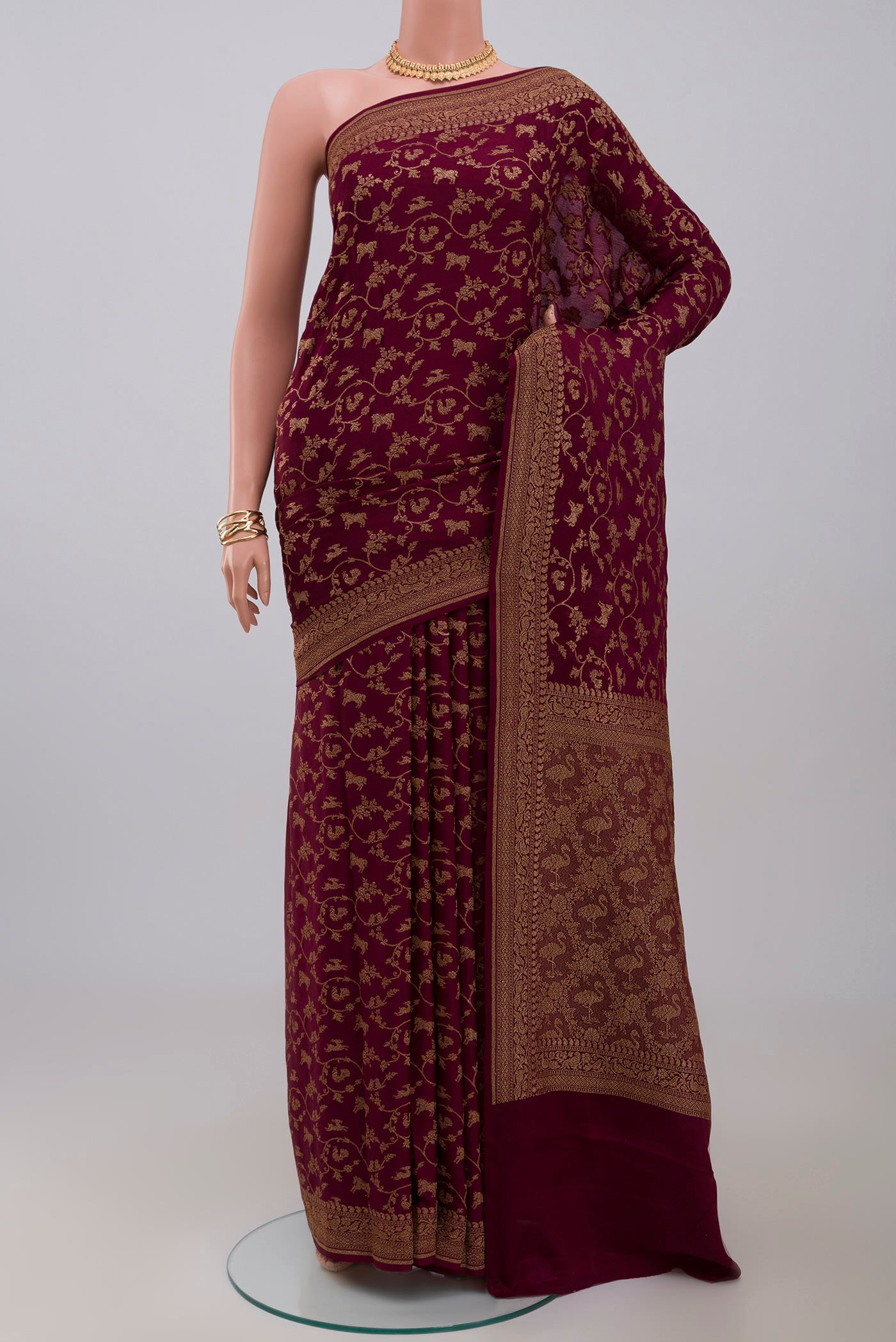 Brown Georgette Saree with Fancy on the body and Zari Border.  displayed on a mannequin