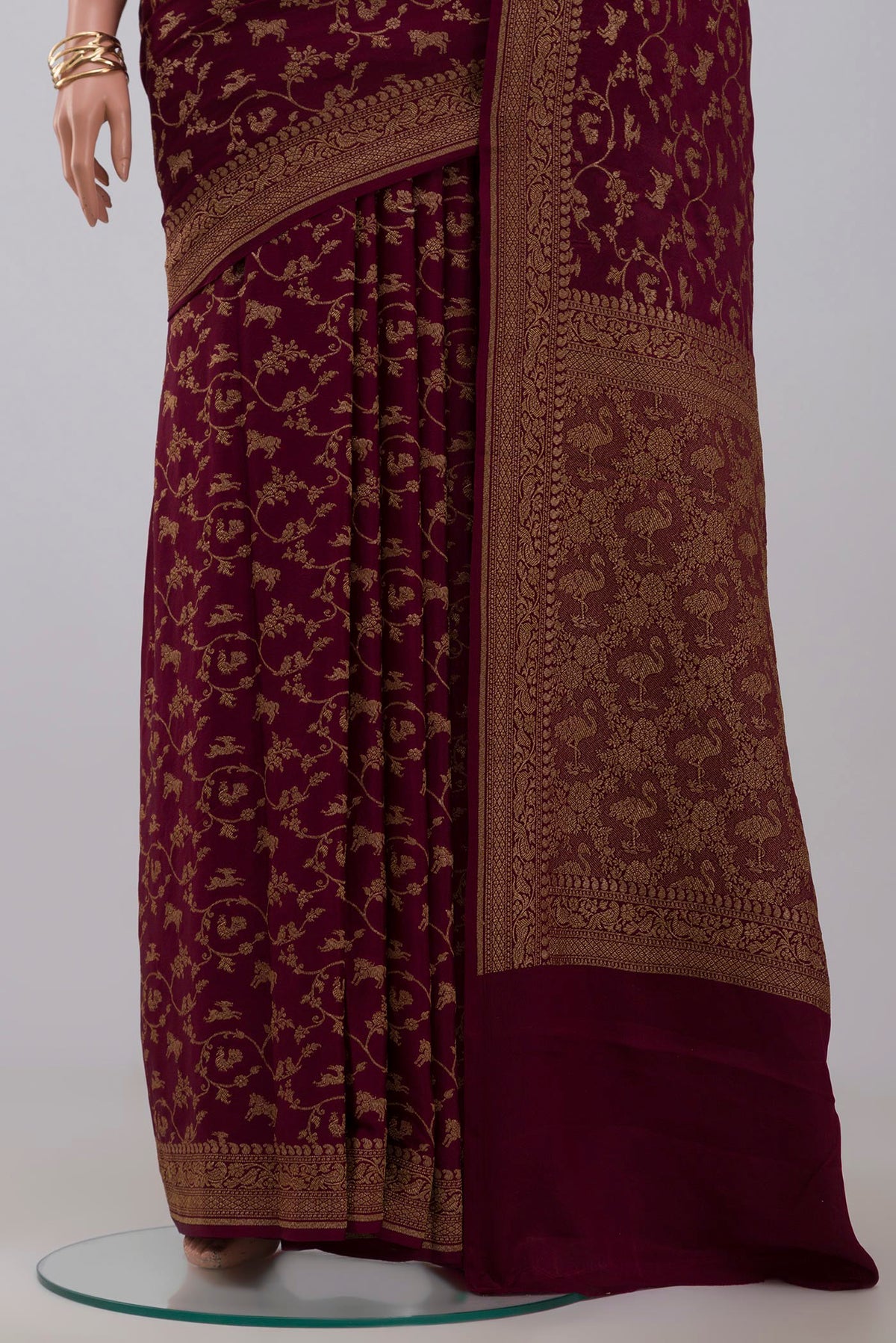 Pleats and pallu of Brown Georgette Saree with Fancy on the body and Zari Border. 