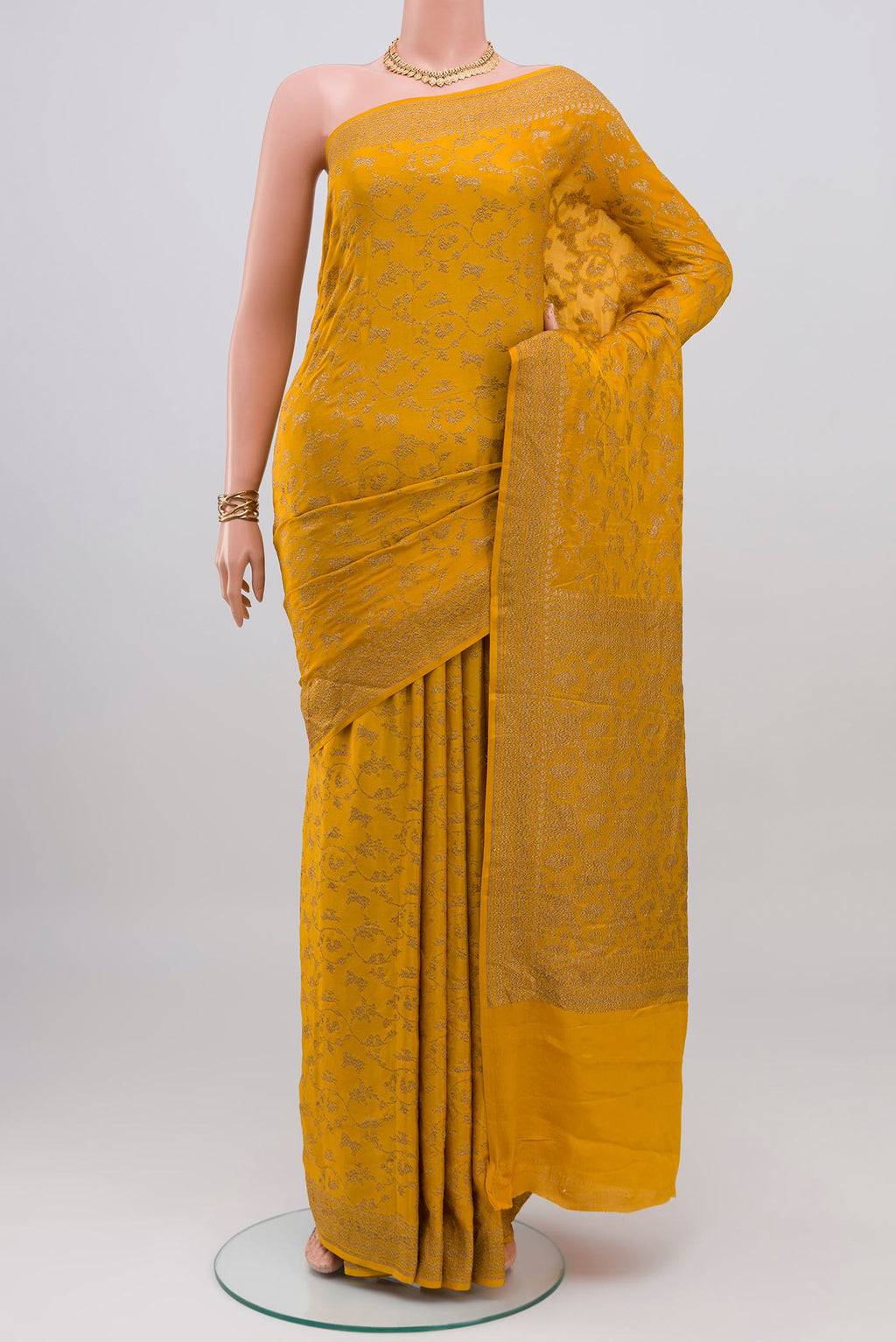Yellow Banarasi Georgette Saree with Zari Butta on the body and Zari Border.  displayed on a mannequin