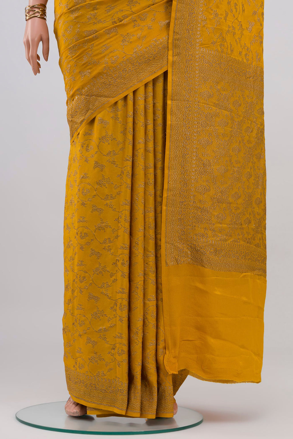 Pleats and pallu of Yellow Banarasi Georgette Saree with Zari Butta on the body and Zari Border. 