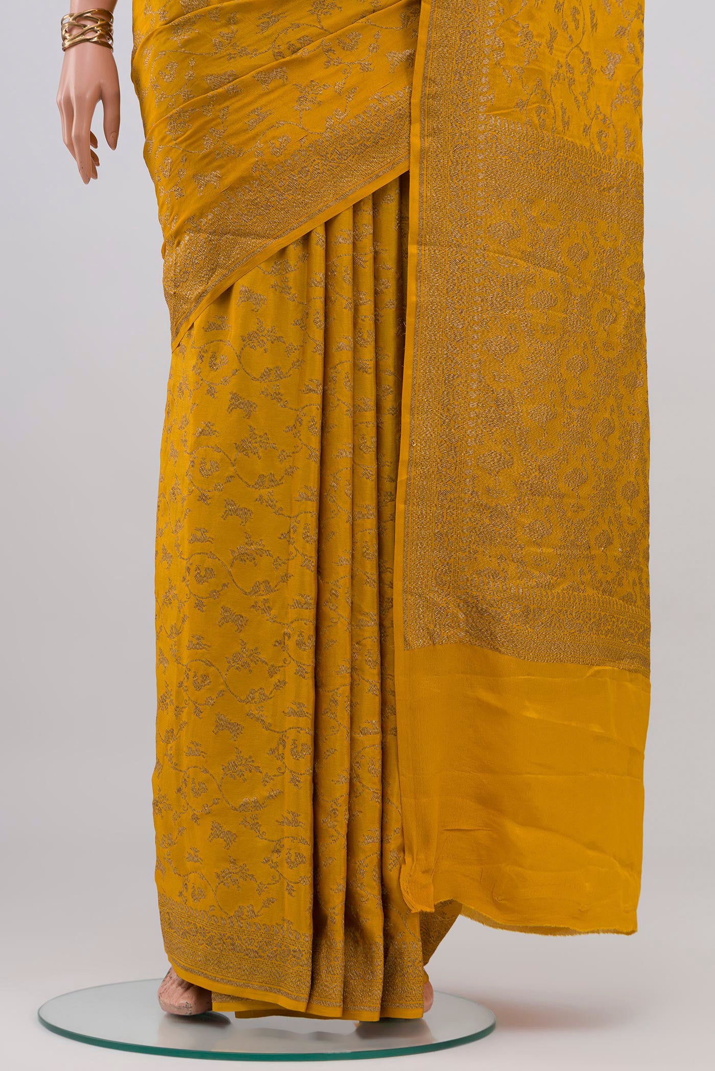 Pleats and pallu of Yellow Banarasi Georgette Saree with Zari Butta on the body and Zari Border. 