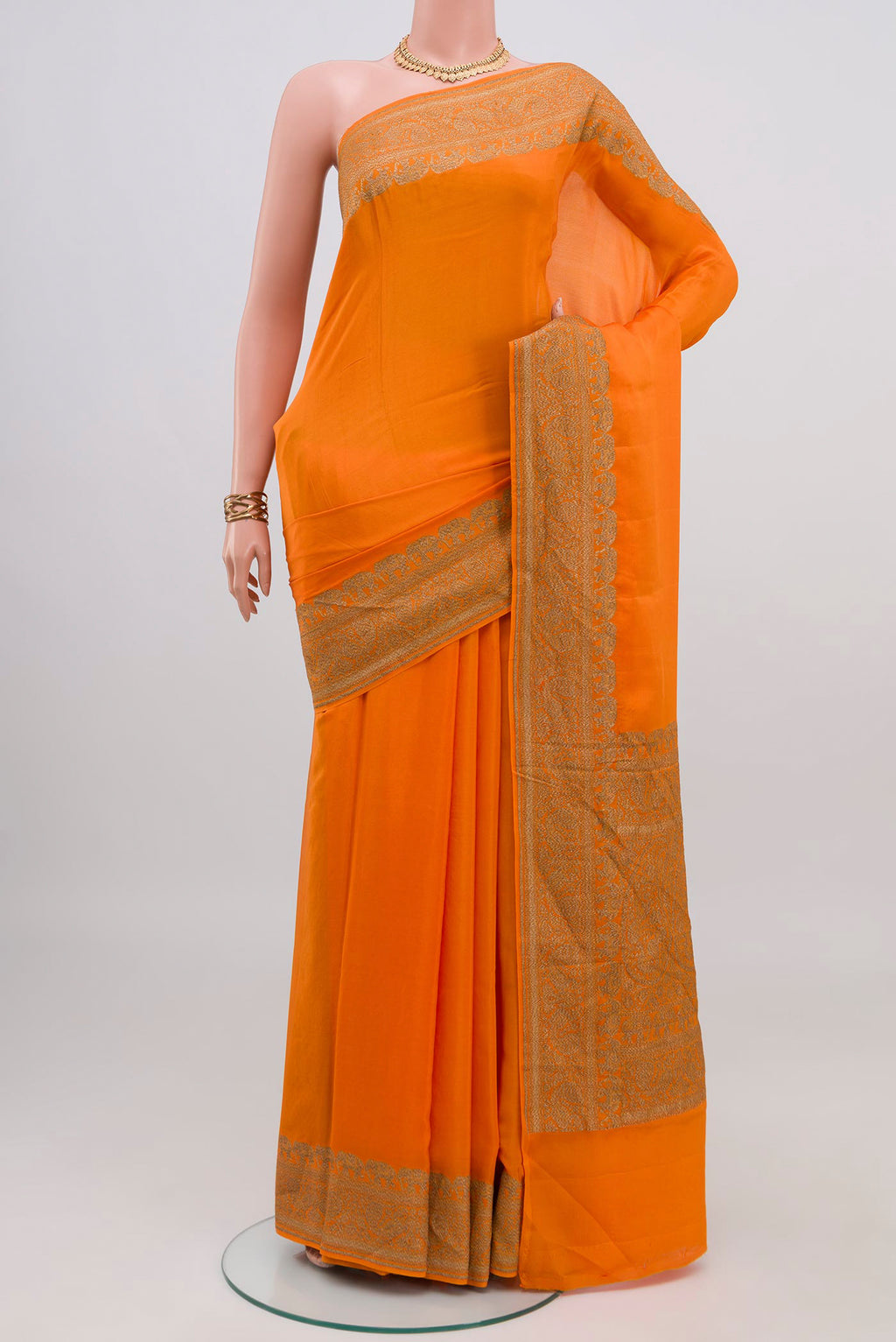 Orange Banarasi Georgette Saree with Plain Body and Zari Border.  displayed on a mannequin