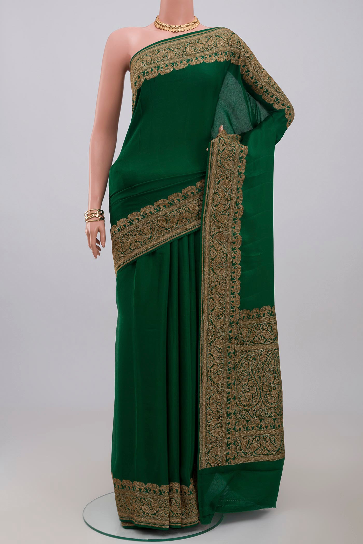 Green Georgette Saree with Plain Body and Zari Border.  displayed on a mannequin