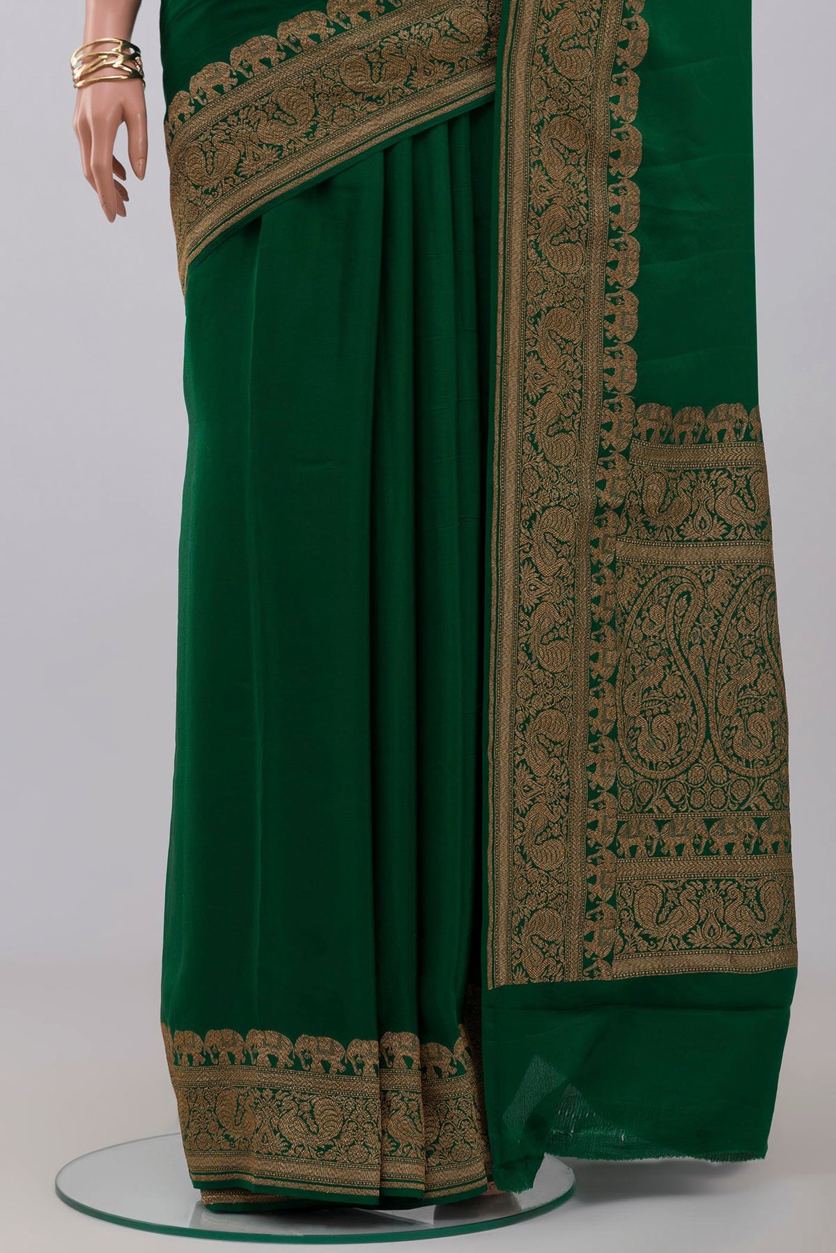 Pleats and pallu of Green Georgette Saree with Plain Body and Zari Border. 