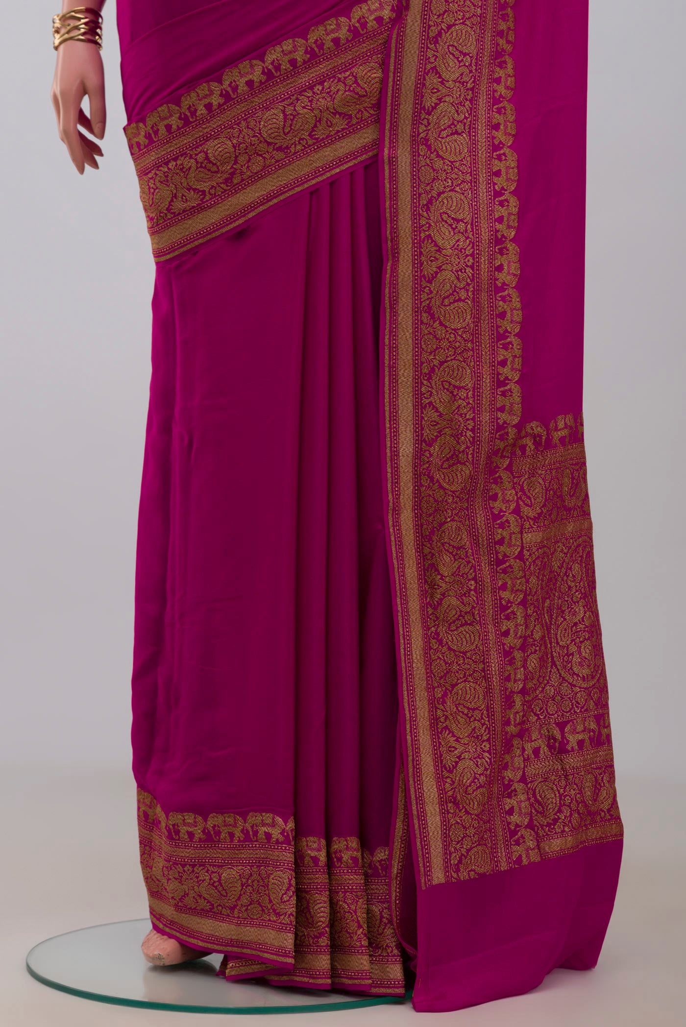 Pleats and pallu of Pink Georgette Saree with Plain Body and Fancy Border. 