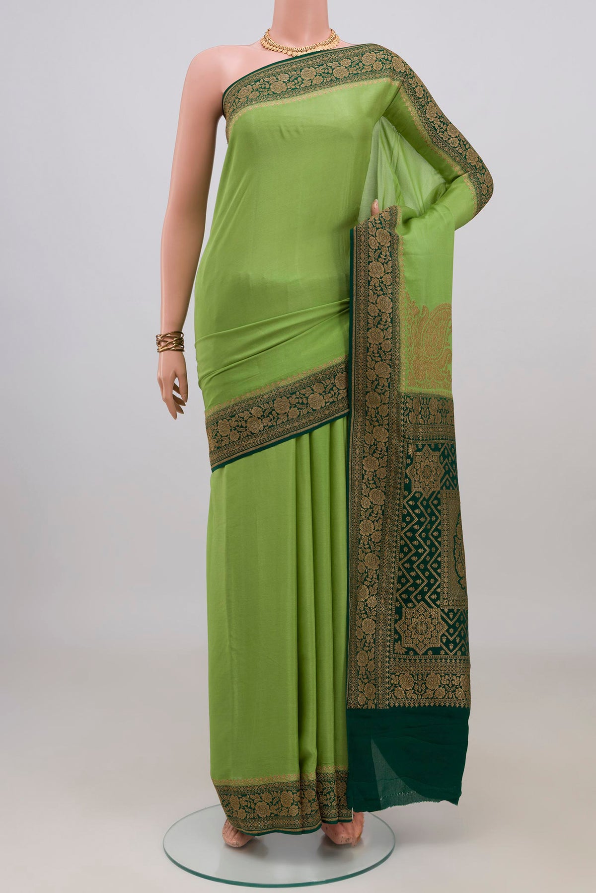 Pista Green Banarasi Georgette Saree with Plain Body and Zari Border.  displayed on a mannequin