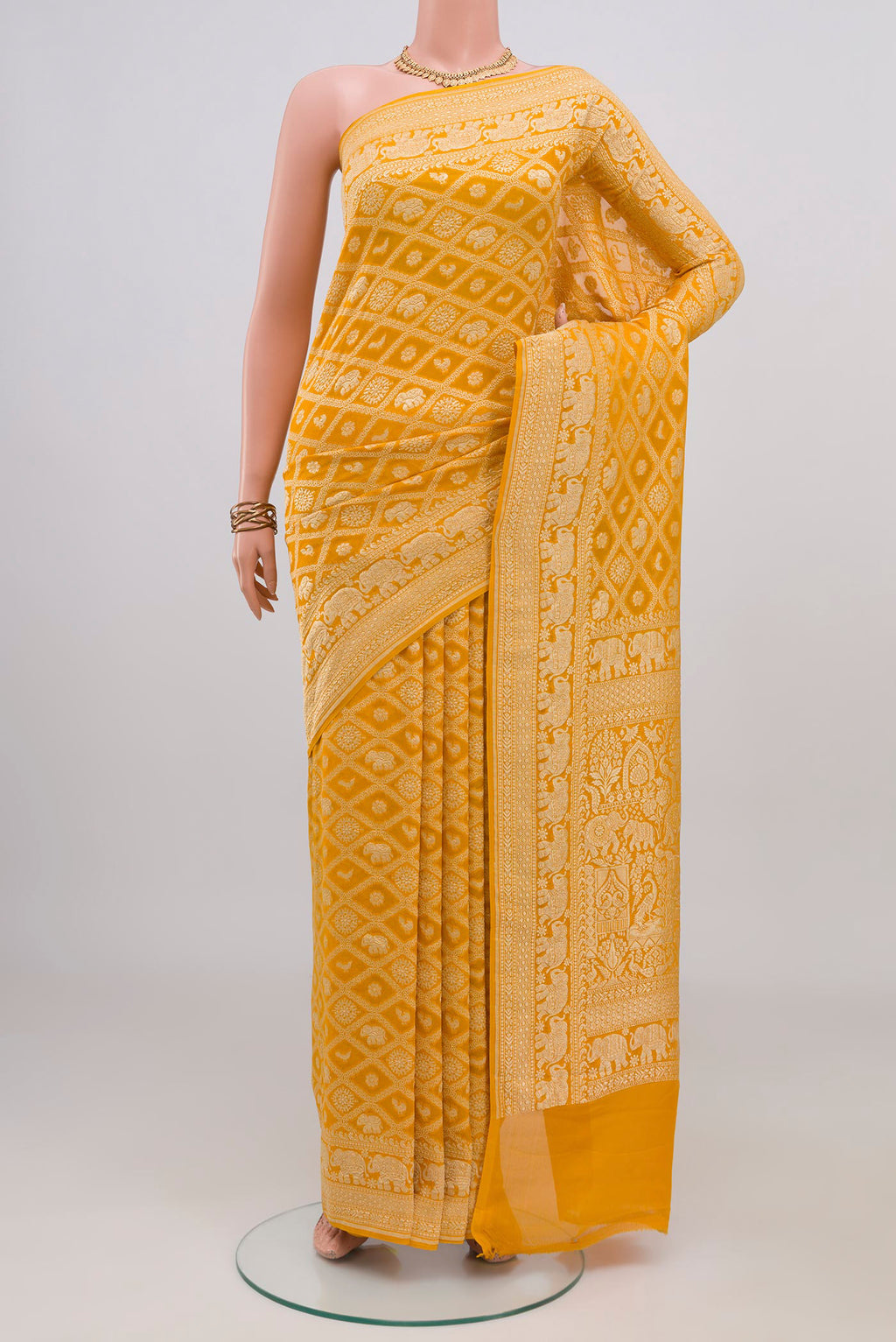 Yellow Banarasi Georgette Saree with Zari Brocade on the body and Zari Border.  displayed on a mannequin