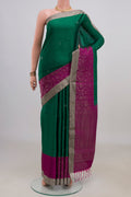Pure Silk Green Soft Saree with Zari Butta on the body and Zari Border.  displayed on a mannequin