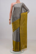 Pure Silk Grey Soft Saree with Zari Butta on the body and Fancy Border.  displayed on a mannequin