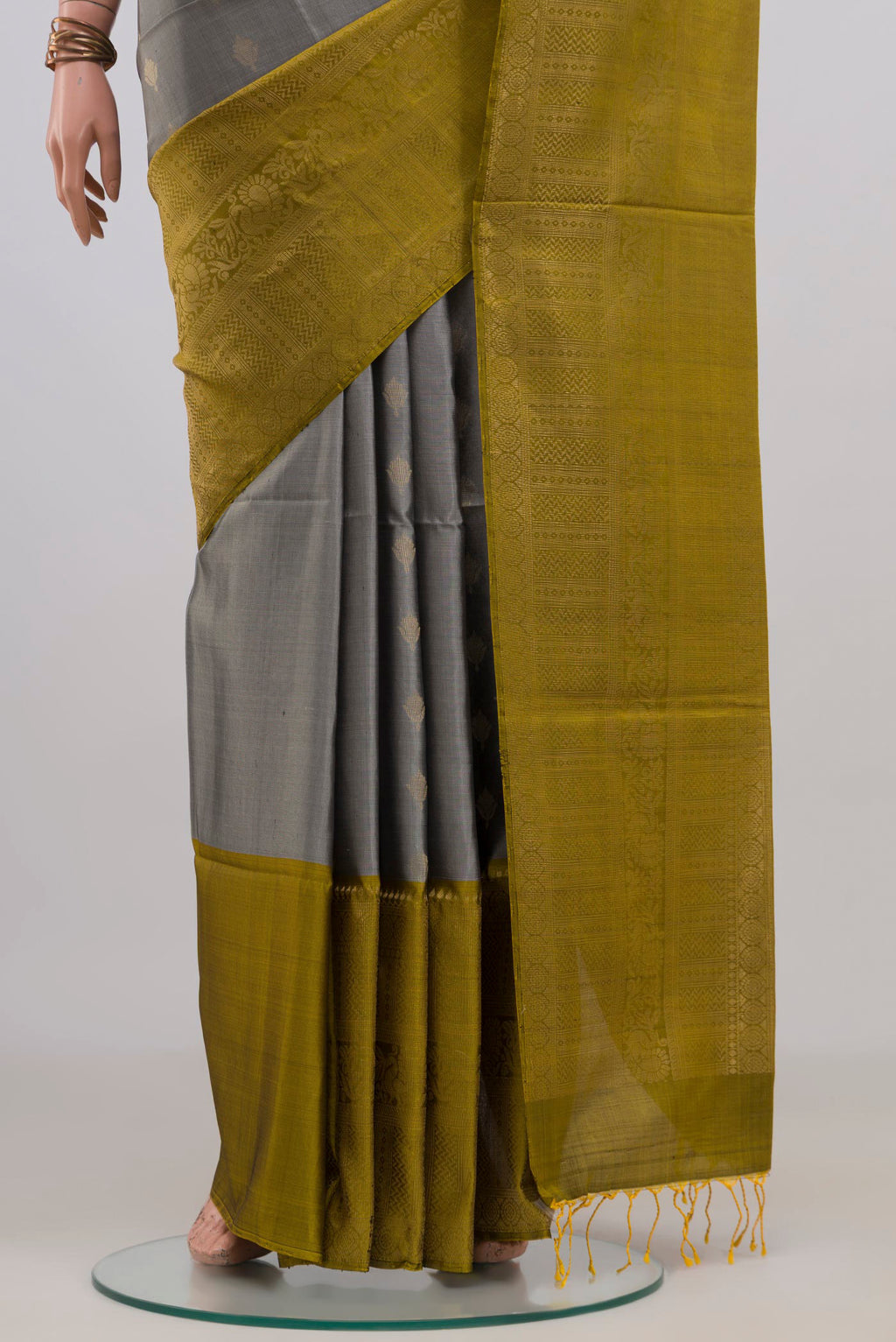 Pleats and pallu of Pure Silk Grey Soft Saree with Zari Butta on the body and Fancy Border. 