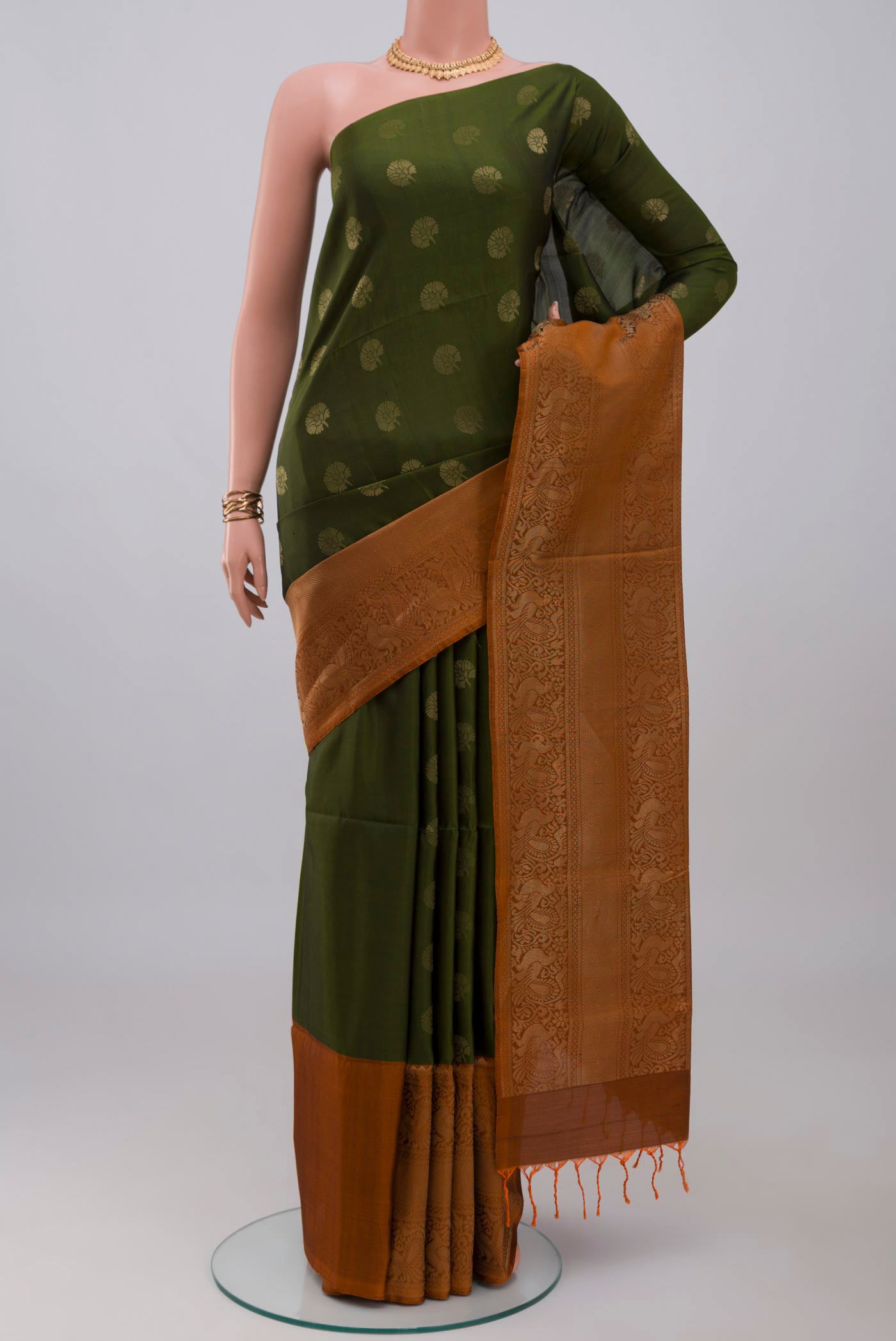 Mehandi Green Soft Silk Saree with Zari Butta on the body and Fancy Border.  displayed on a mannequin
