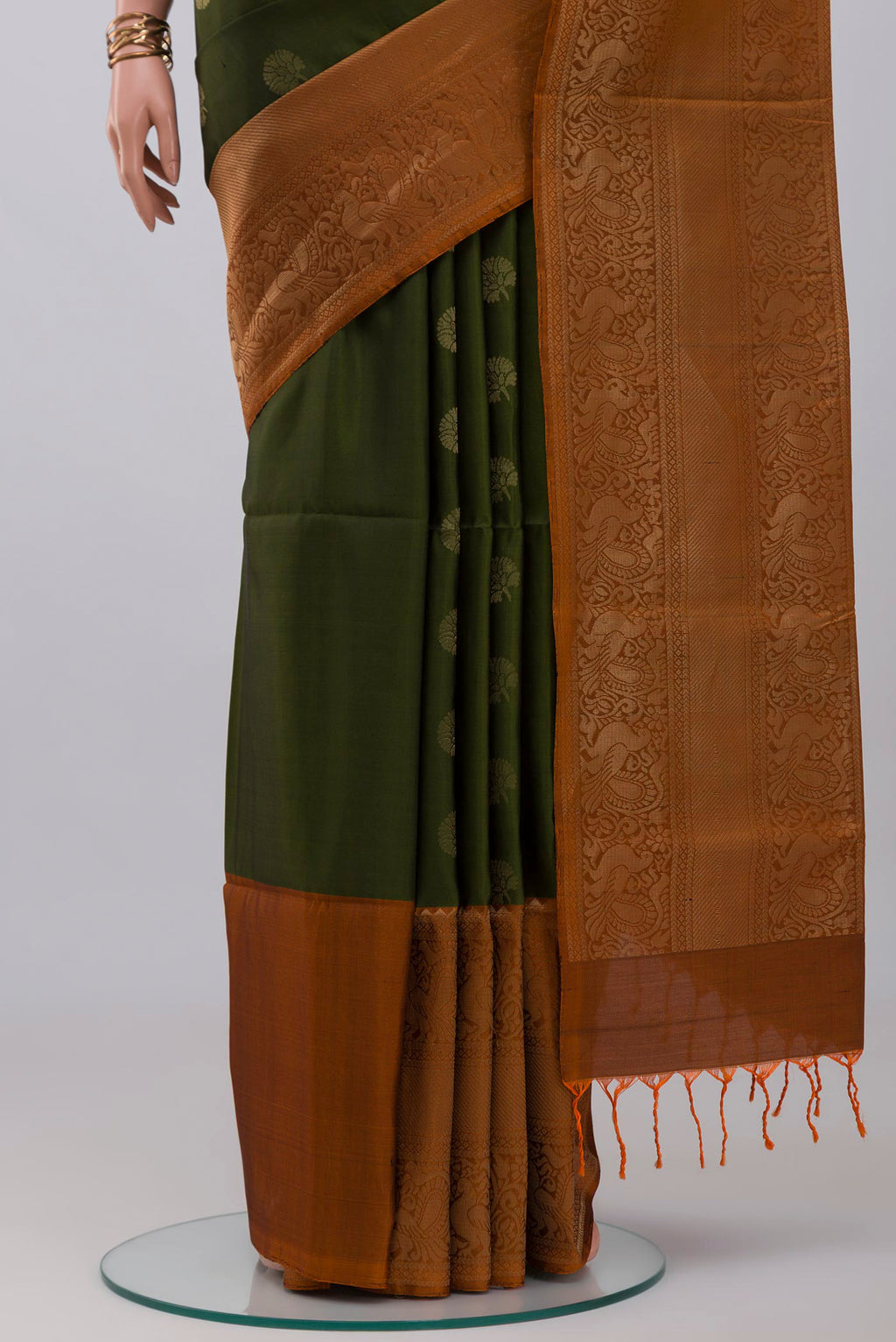 Pleats and pallu of Mehandi Green Soft Silk Saree with Zari Butta on the body and Fancy Border. 