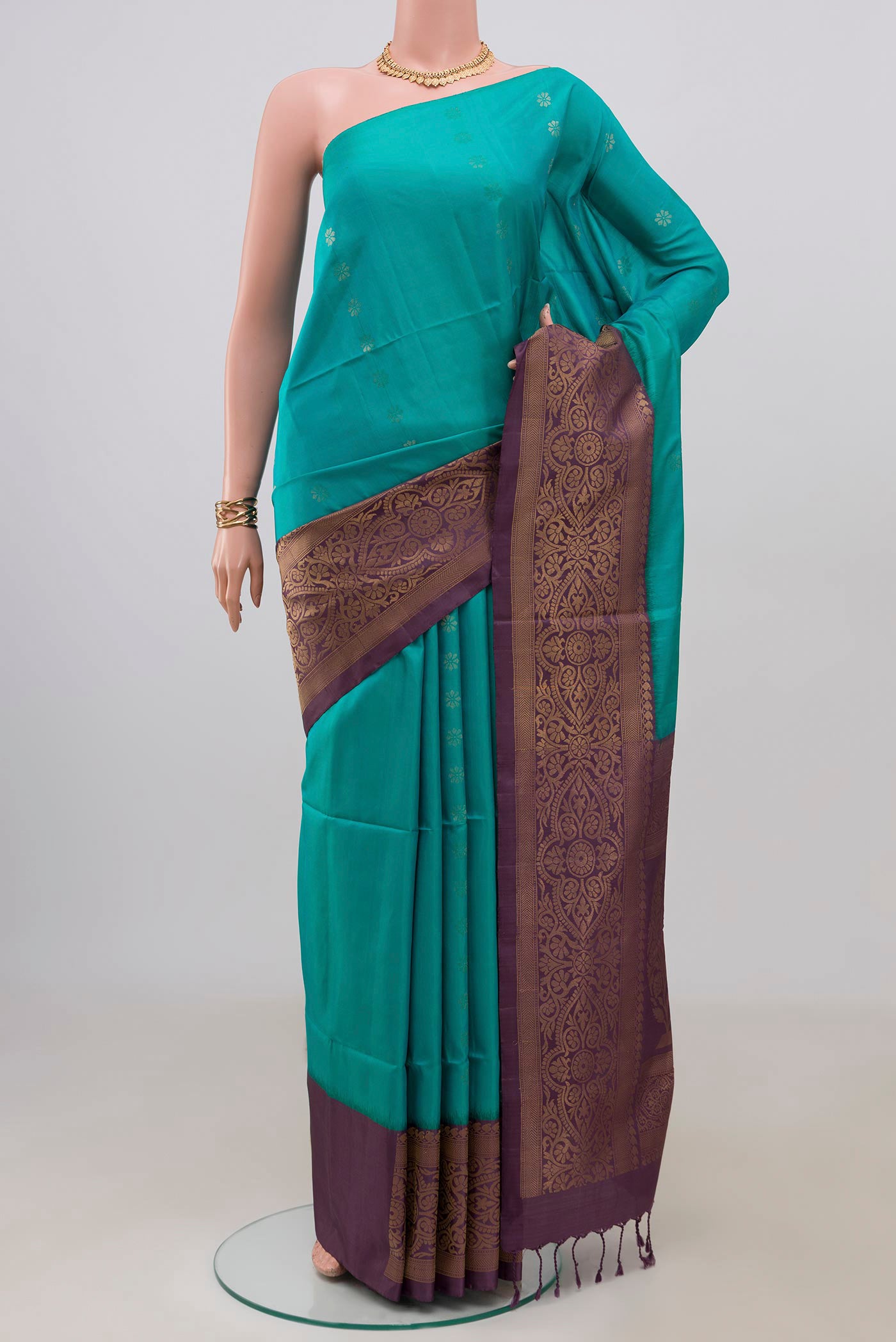Peacock Blue Soft Silk Saree with Zari Butta on the body and Fancy Border.  displayed on a mannequin