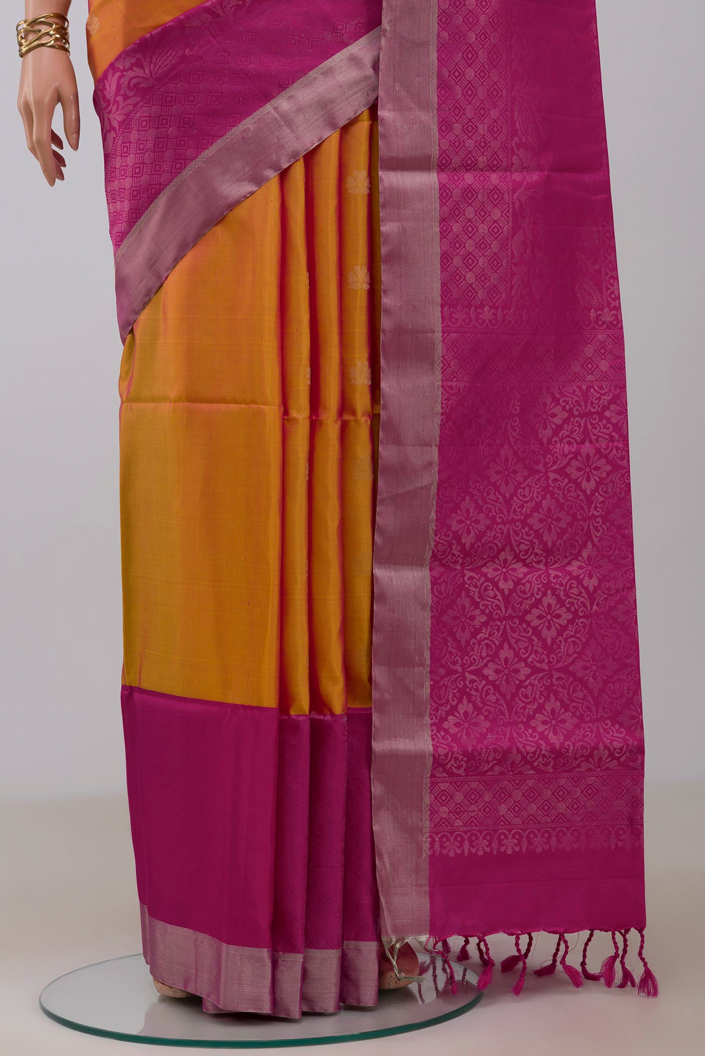 Pleats and pallu of Yellow Soft Silk Saree with Zari Butta on the body and Fancy Border. 