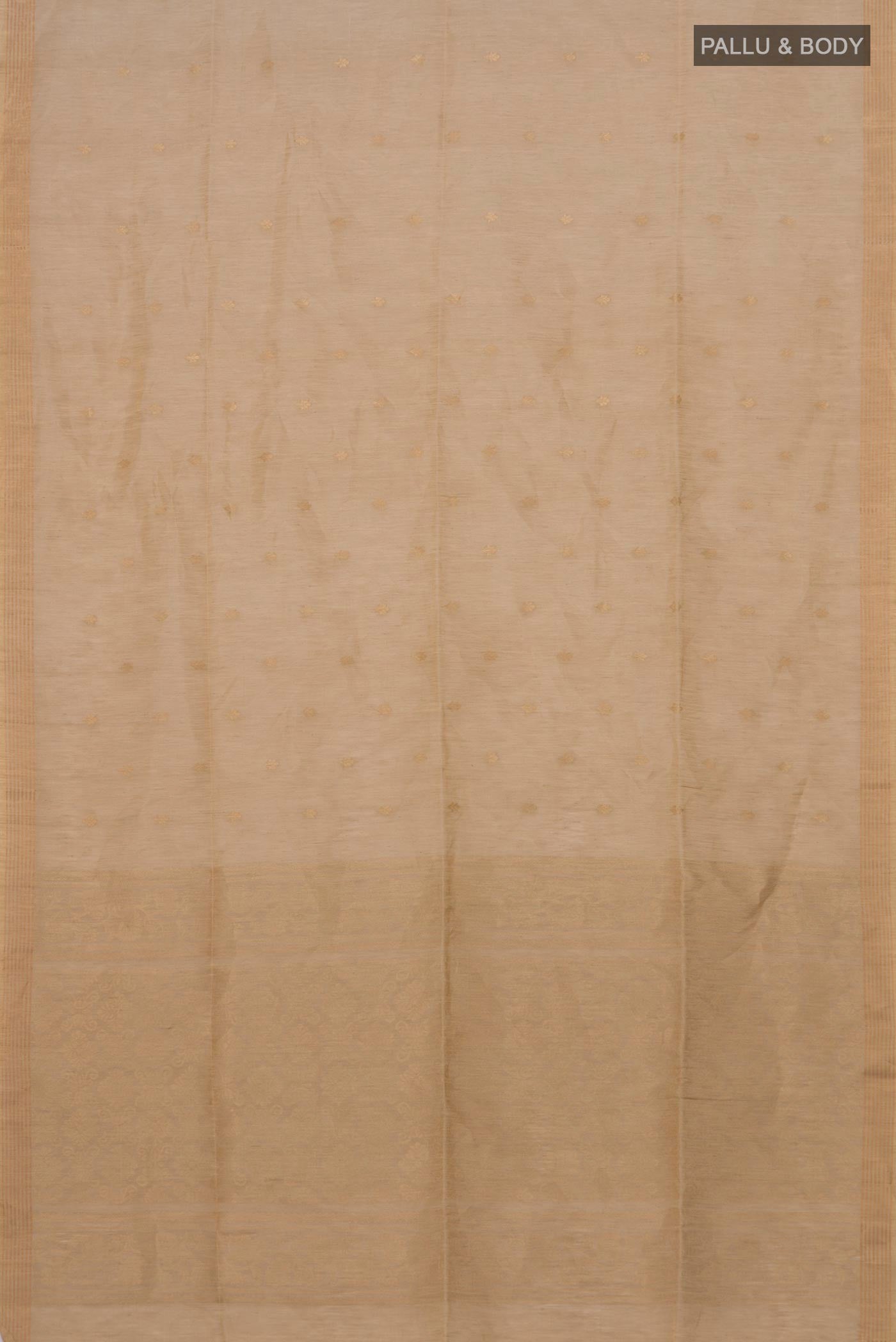 Flat view of Beige Soft Silk Saree with Zari Butta on the body and Thin Zari Line. 