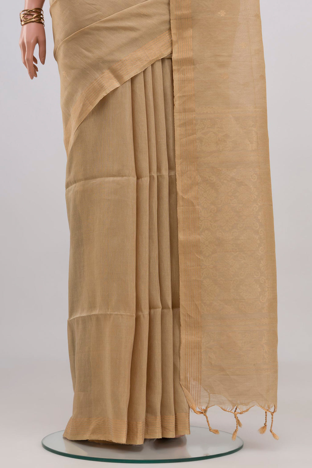 Pleats and pallu of Beige Soft Silk Saree with Zari Butta on the body and Thin Zari Line. 