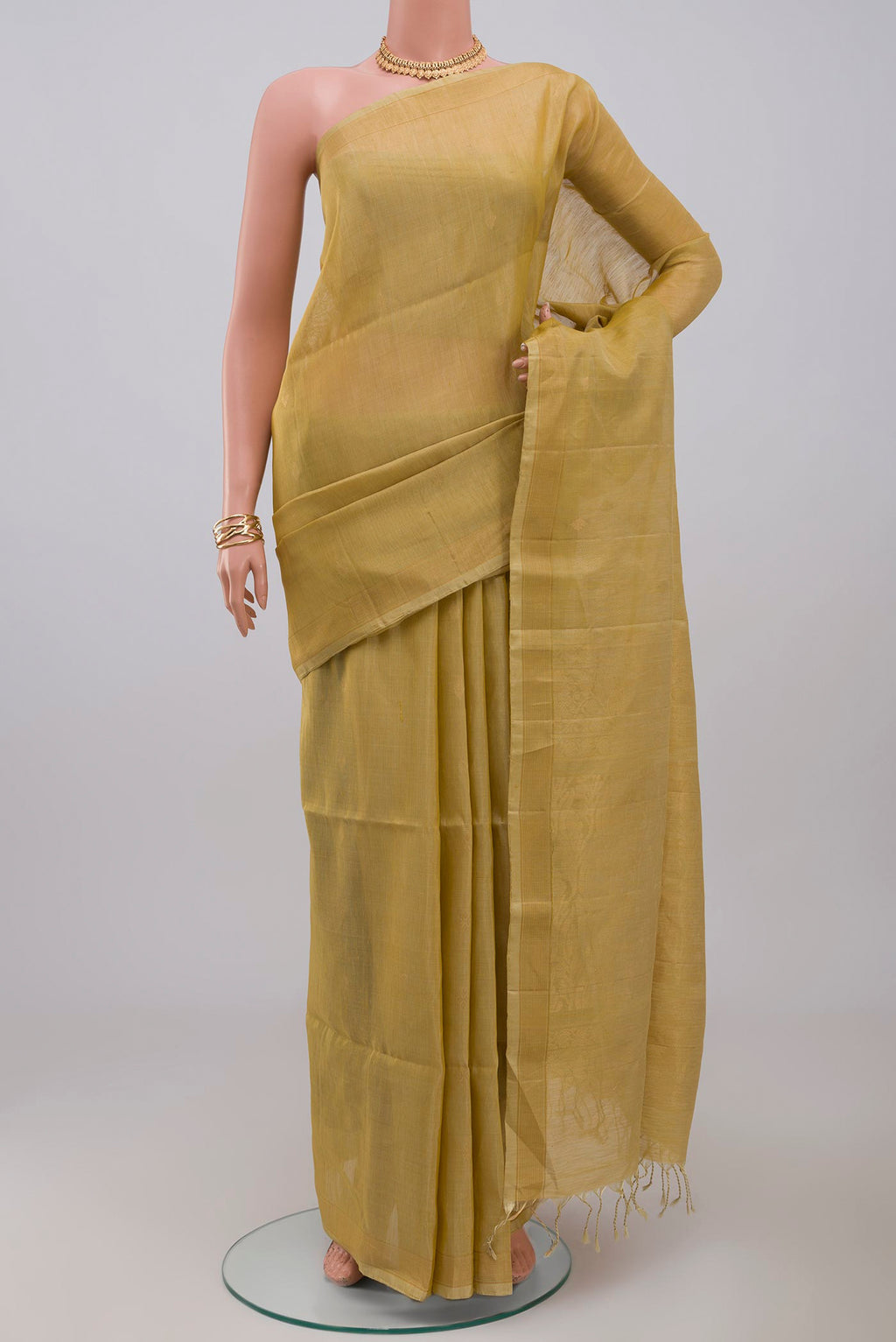 Beige Soft Silk Saree with Zari Butta on the body and Thin Zari Line.  displayed on a mannequin