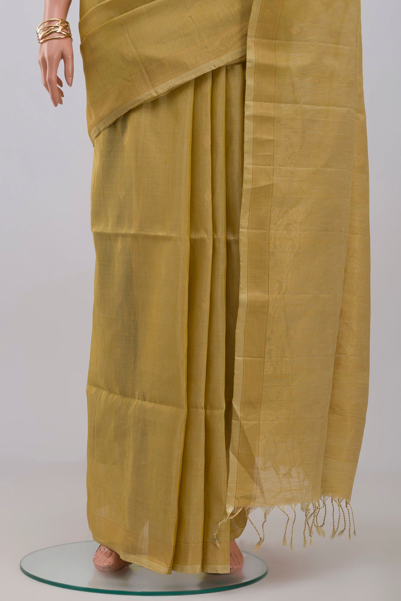 Pleats and pallu of Beige Soft Silk Saree with Zari Butta on the body and Thin Zari Line. 