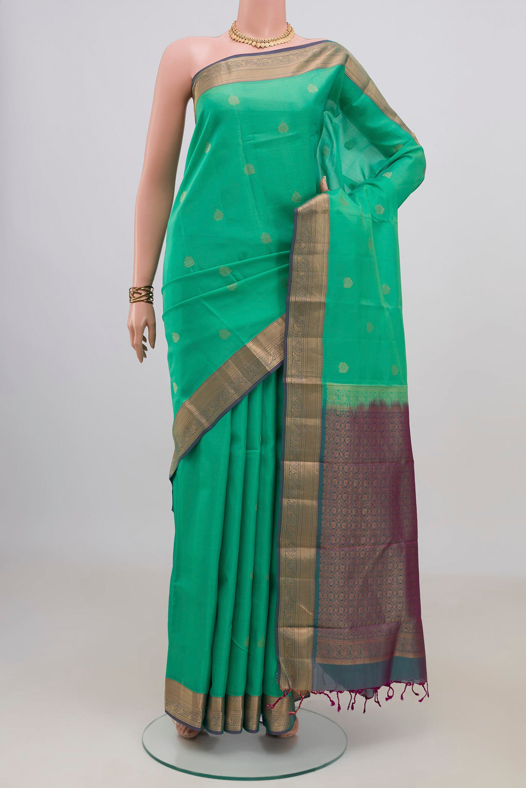 Pure Silk Green Soft Saree with Zari Butta on the body and Zari Border.  displayed on a mannequin